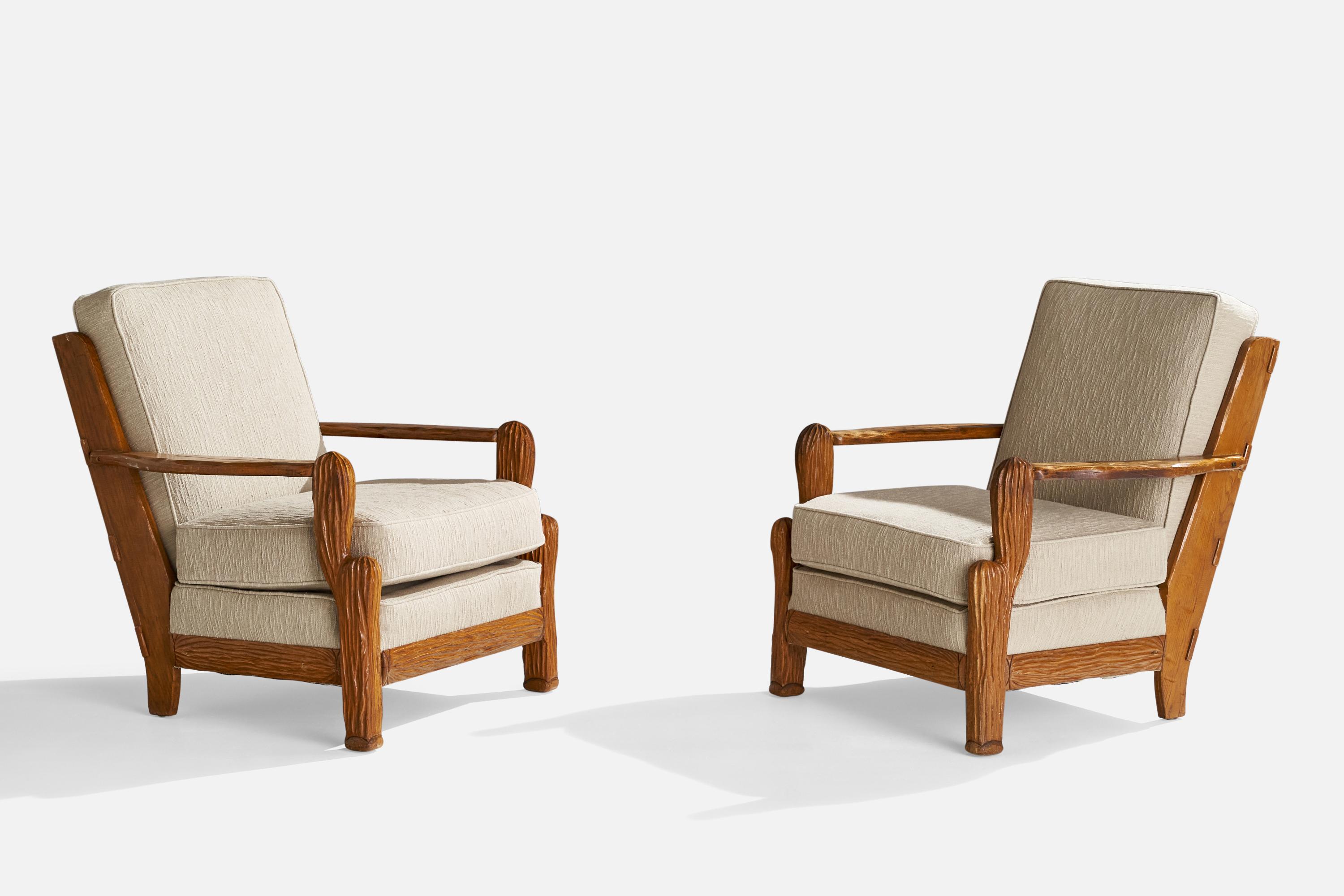 A pair of oak and off-white fabric lounge chairs designed and produced by A. Brandt Ranch Oak, USA, c. 1950s.

Seat height: 18”