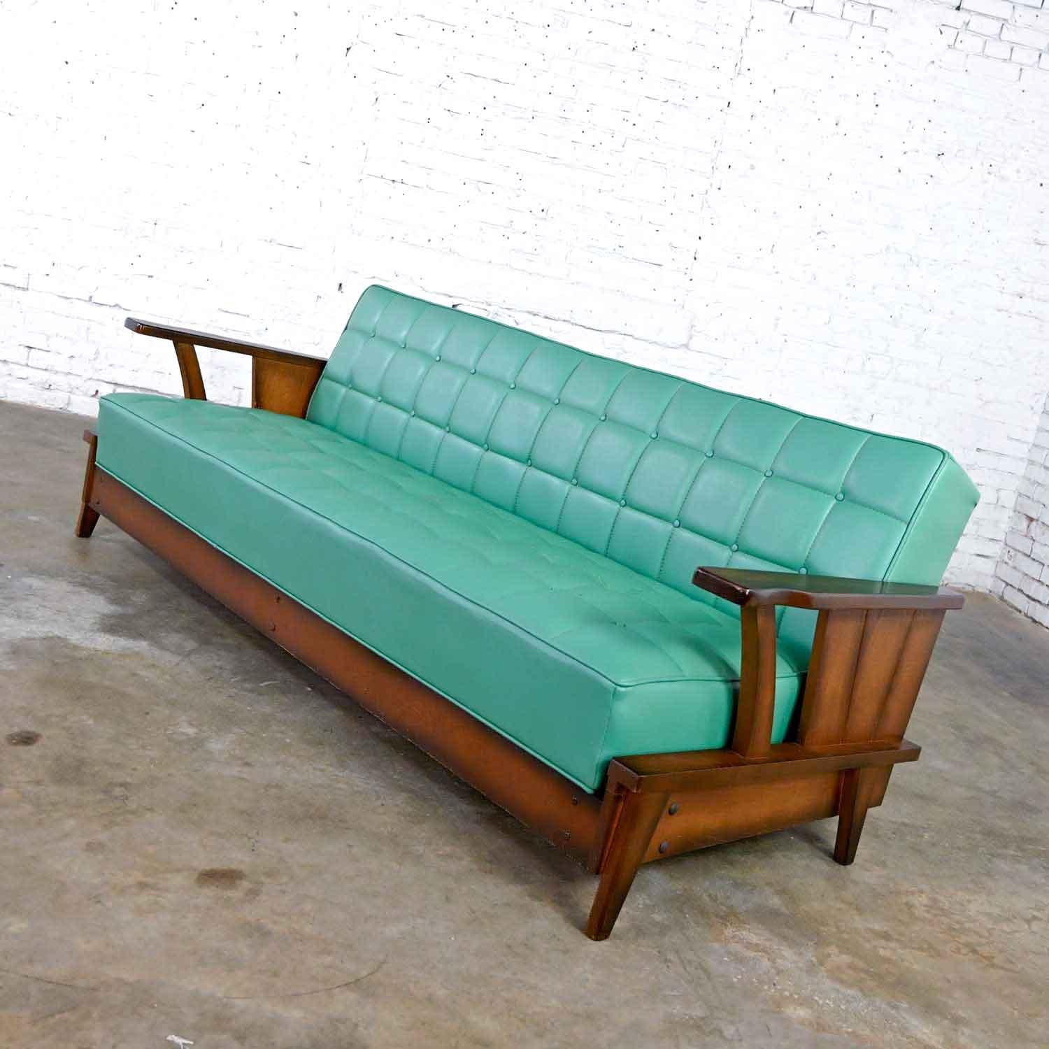 Gorgeous convertible sofa or daybed comprised of oak and original turquoise vinyl faux leather by Economy Furniture style of A. Brandt Ranch Oak. Age-appropriate condition, keeping in mind that this is vintage and not new so will have signs of use