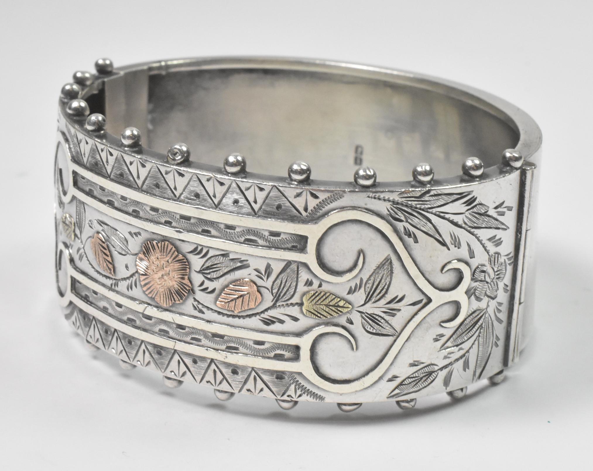 A. Brandt & Son Victorian sterling silver mixed metals bangle bracelet. Circa 1880's. Stamped inside with several English hallmarks. Inlaid rose gold of flowers and leaves. Inscription on back as photo'd. Good condition with a small dent near the