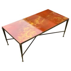A brass and lacquer top coffee table