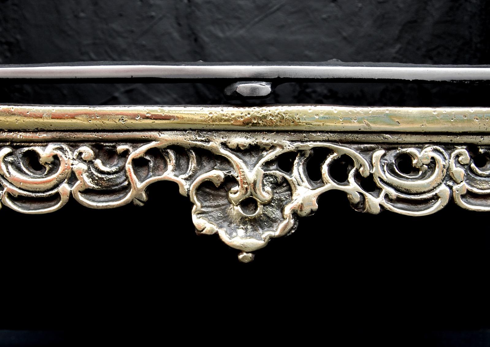 A brass and steel French Rococo fire basket. The decoratively cast brass legs with shaped steel burning area. Decorative cast iron back behind. Modern. 

Sizes
Width At Front:	572 mm      	22 1/2 in
Width At Back:	485 mm      	19 1/8 in
Height:	745