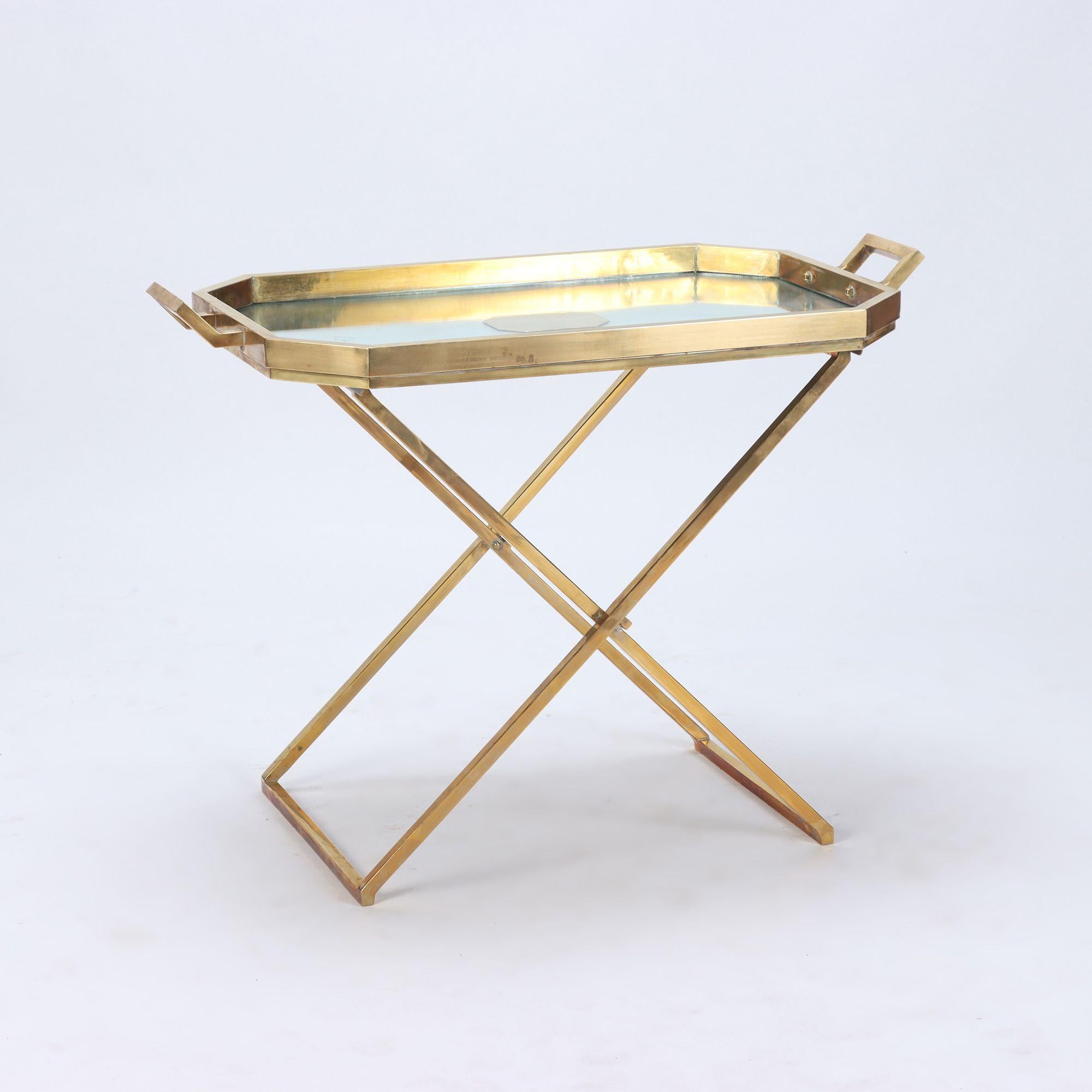 A brass butlers tray on stand of generous proportions C 1970. The tray has a mirrored surface and is removable. The base folds up for storage.