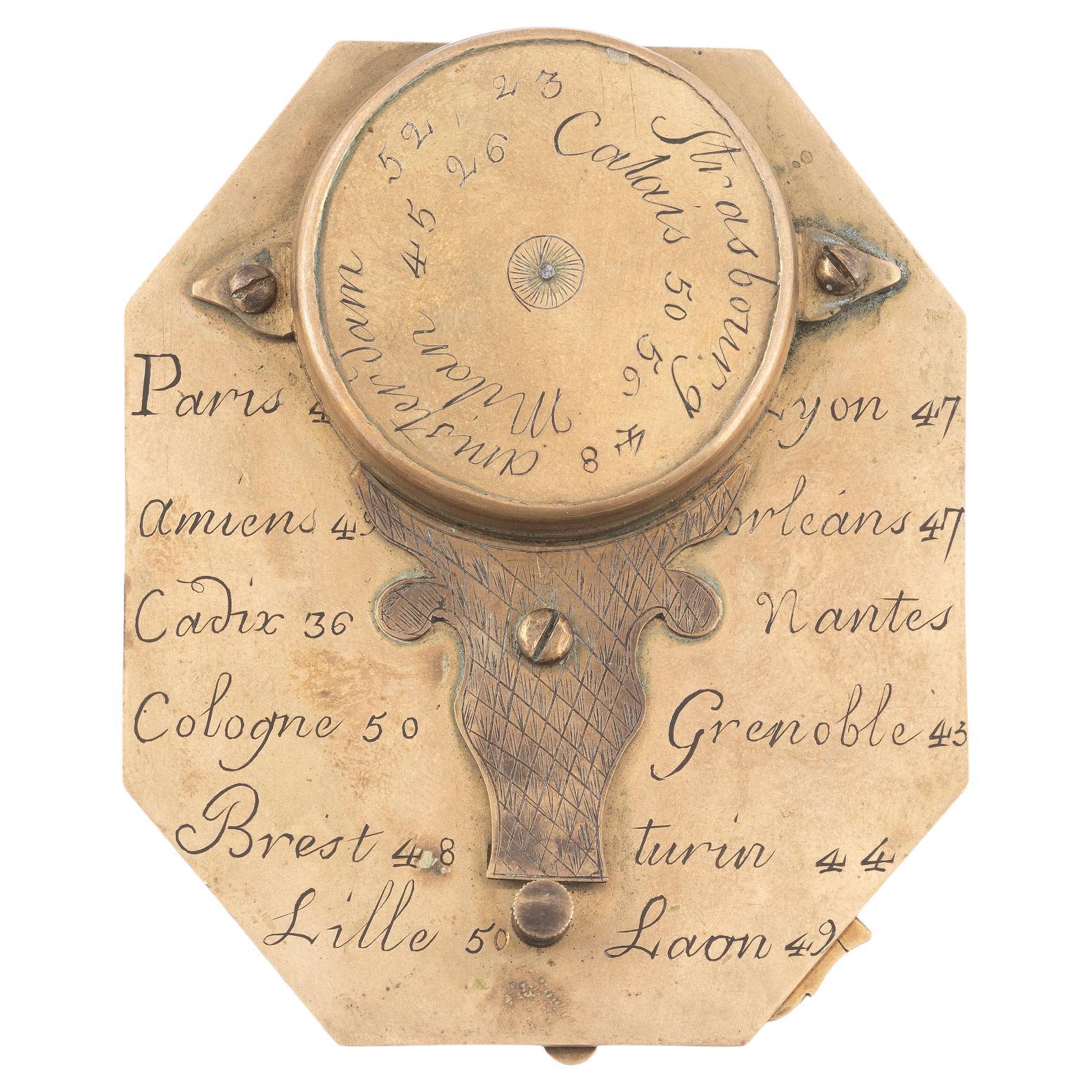 signed Buterfield A Paris., the octagonal dial with hinged gnomon and bird pointer, inset compass and engraved with hour scales, the reverse engraved with towns and their latitudes, 2¾in (7cm) long