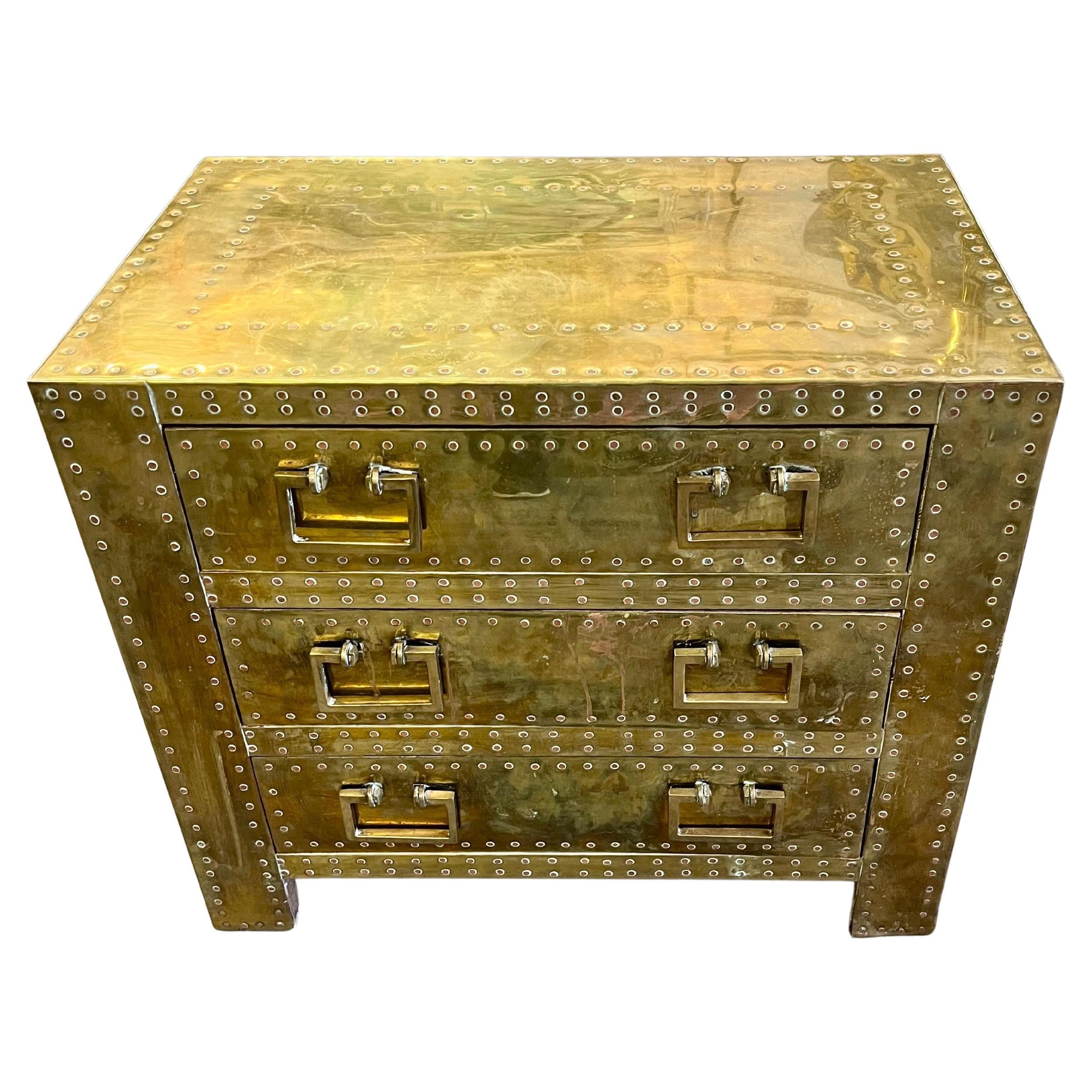 A brass clad 3 drawer chest of drawers by Sarreid, Ltd.