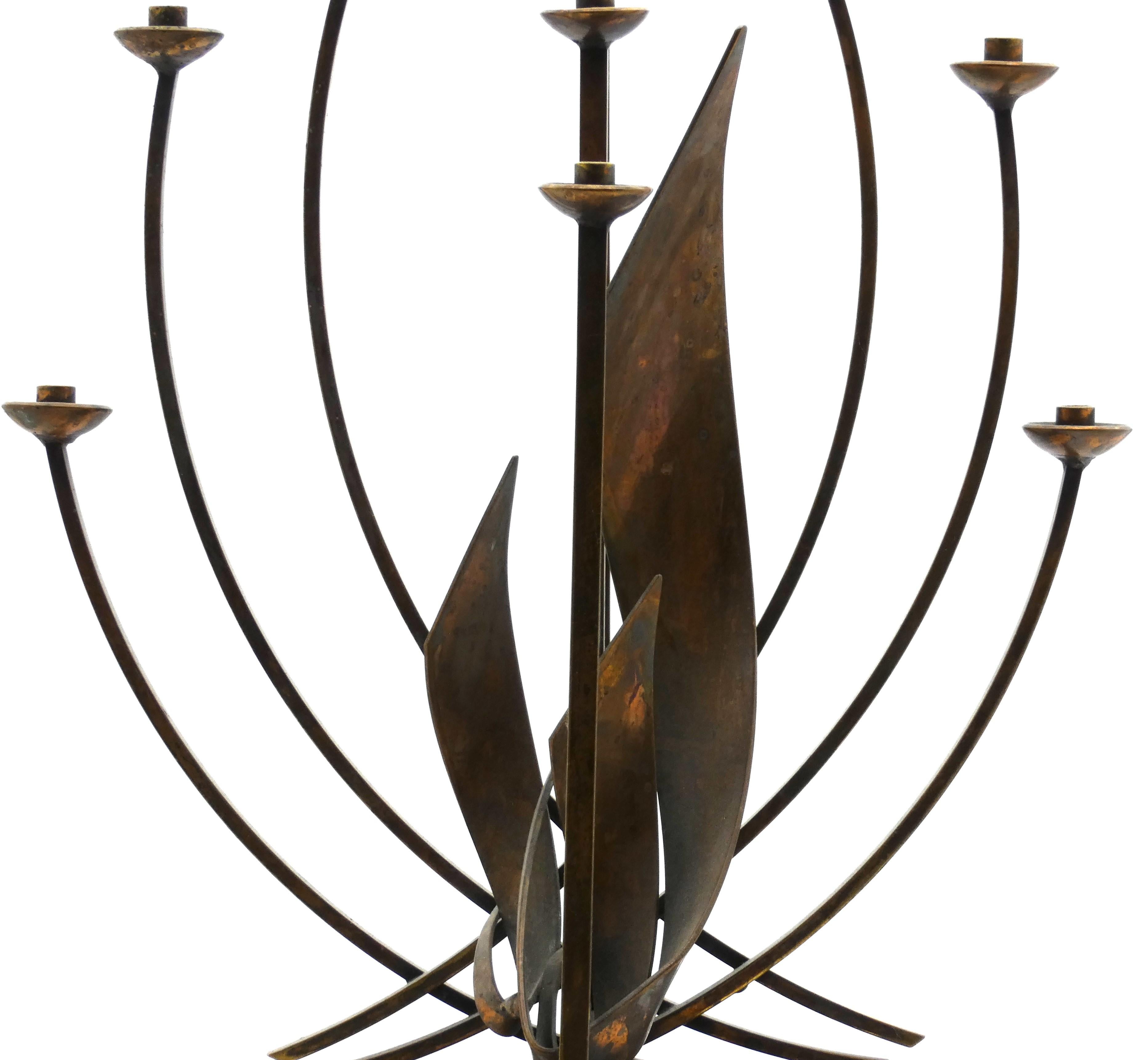 Modern brass Hanukkah Menorah designed by Maxwell Chayat mounted on a wooden block.

Classic modern style of artistry which was known to be Chayat's signature method of designing Hanukah lamps and candlesticks. 

The first thing you notice is the