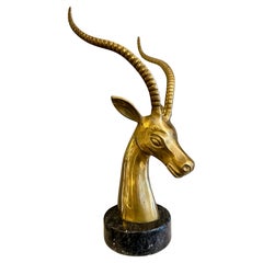 A Brass Impala head And Horns On Black Marble Base