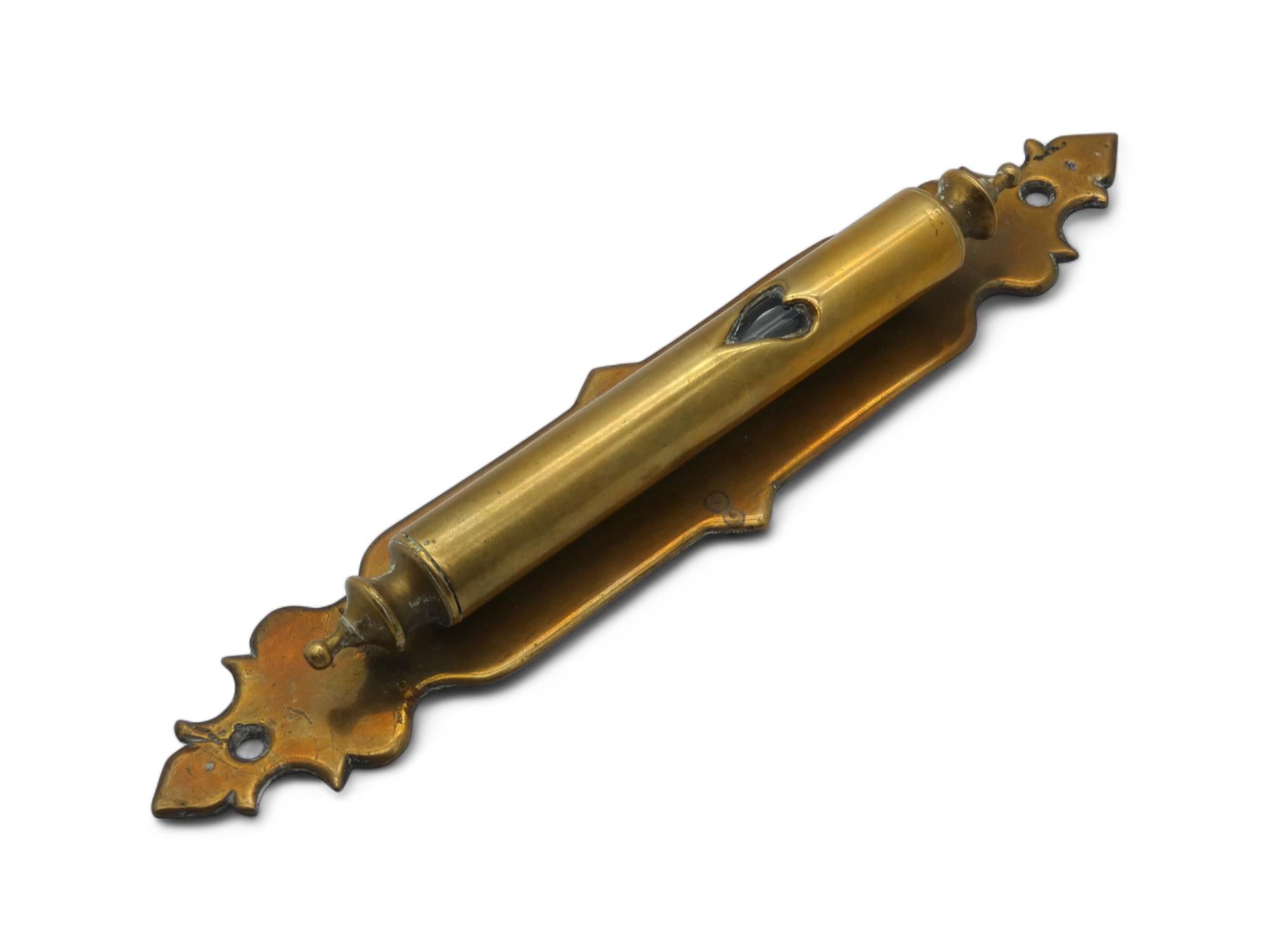 A Stylized Brass Mezuzah Case, Made in India in the Early 20th Century.

From the 19th century through the early 20th century, there was a significant group of Jews that lived in India and made different religious articles and Judaica in their