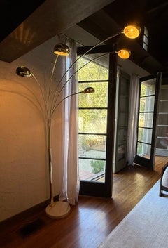 A brass multi-pronged arc floor lamp with marble base, mid 20th century