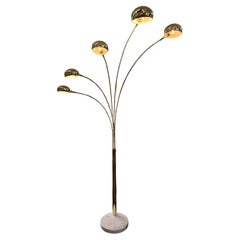 A brass multi-pronged arc floor lamp with marble base, mid 20th century