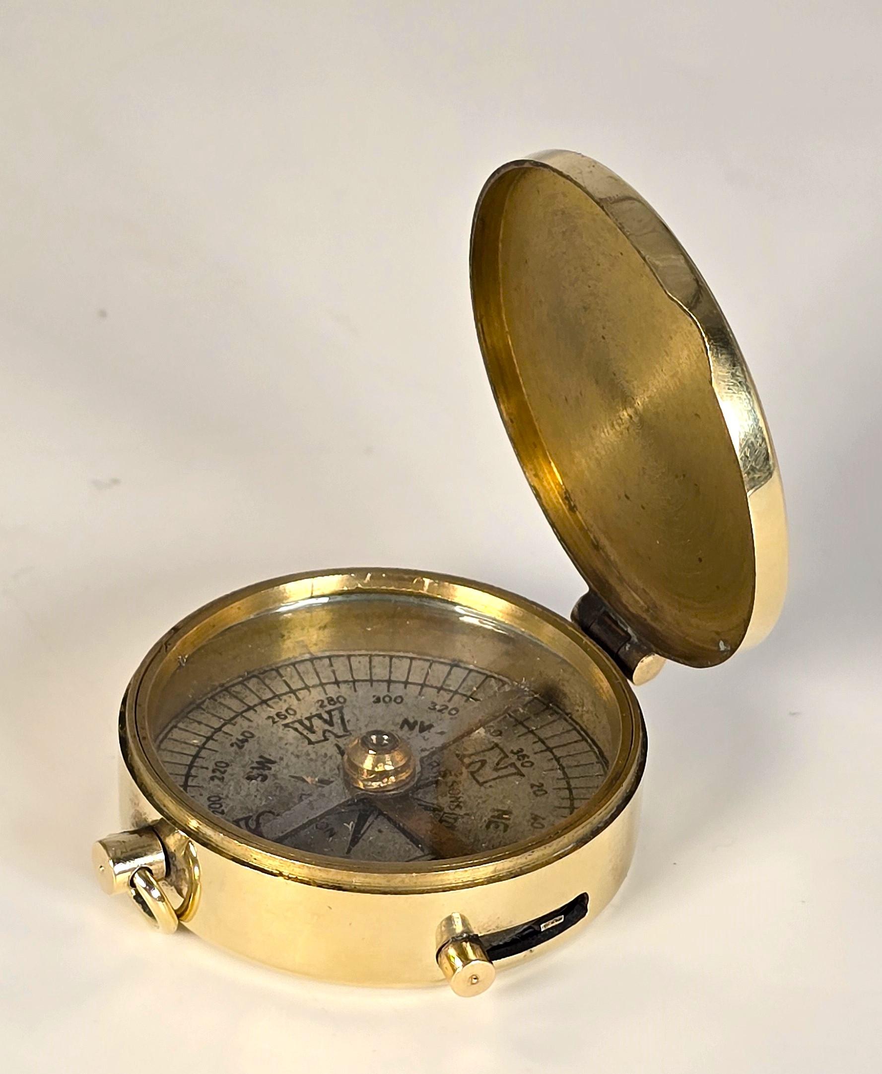This superb compass has an enclosed case, which is made from heavy gauged brass. It is hinged on one side for opening and has a carrying ring opposite. And between there is a sliding knob which operates a leaver mechanism for locking the magnetic