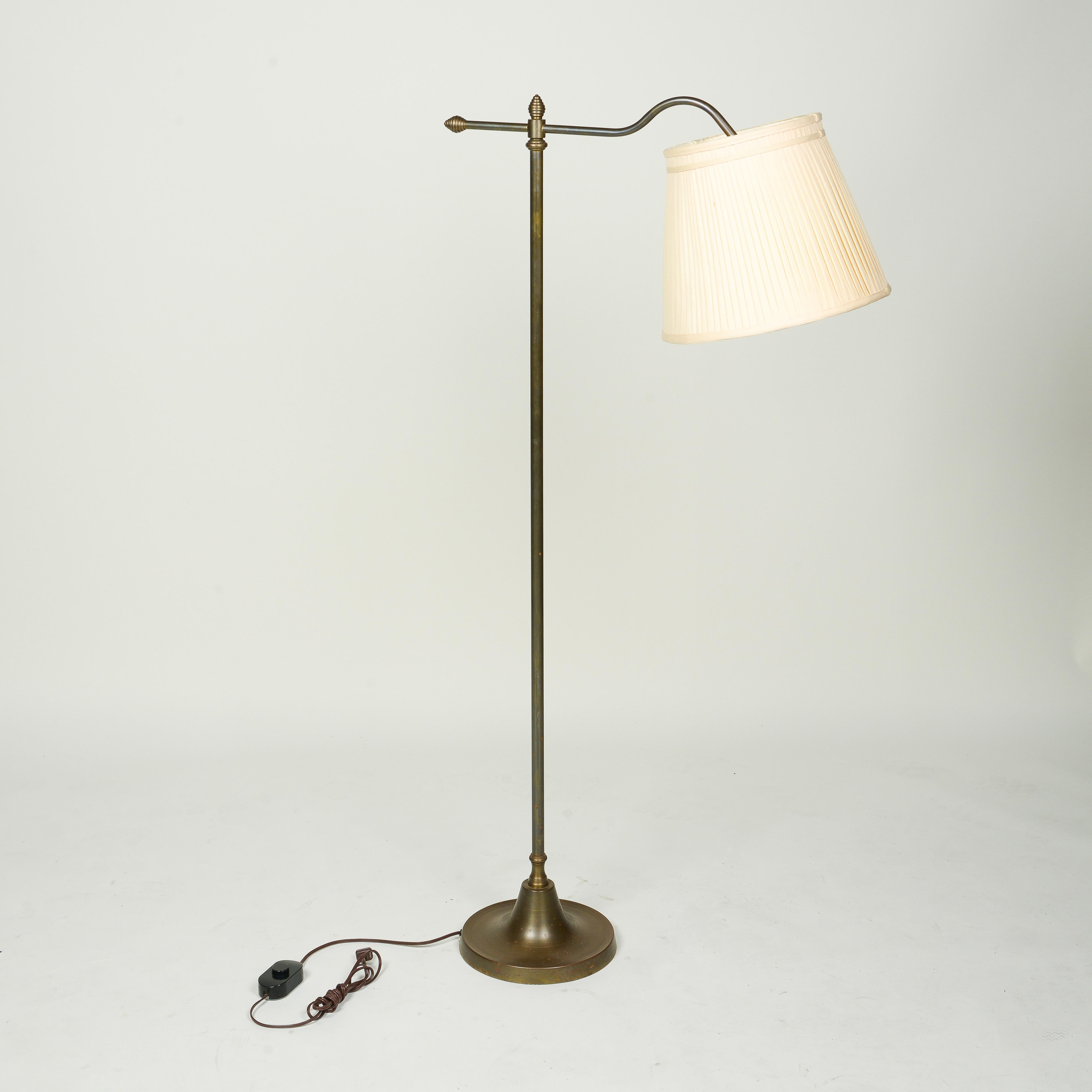 Of columnar form issuing an adjustable arched rod with vintage silk pleated shade; fitted with one bulb socket, on a round plinth base.