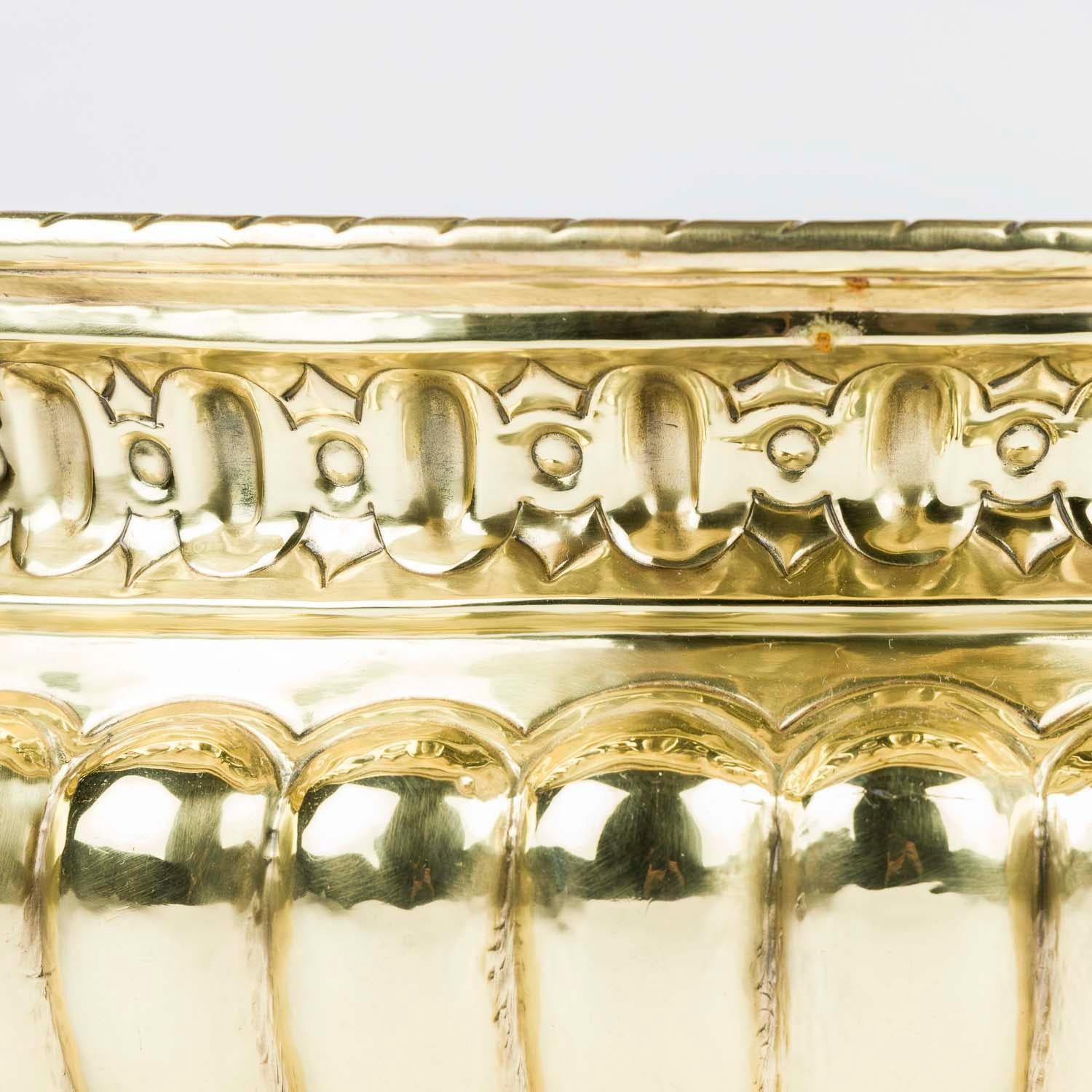 Ottone Una jardinière in ottone repoussé con manici ad anello e piedi a zampa in vendita
