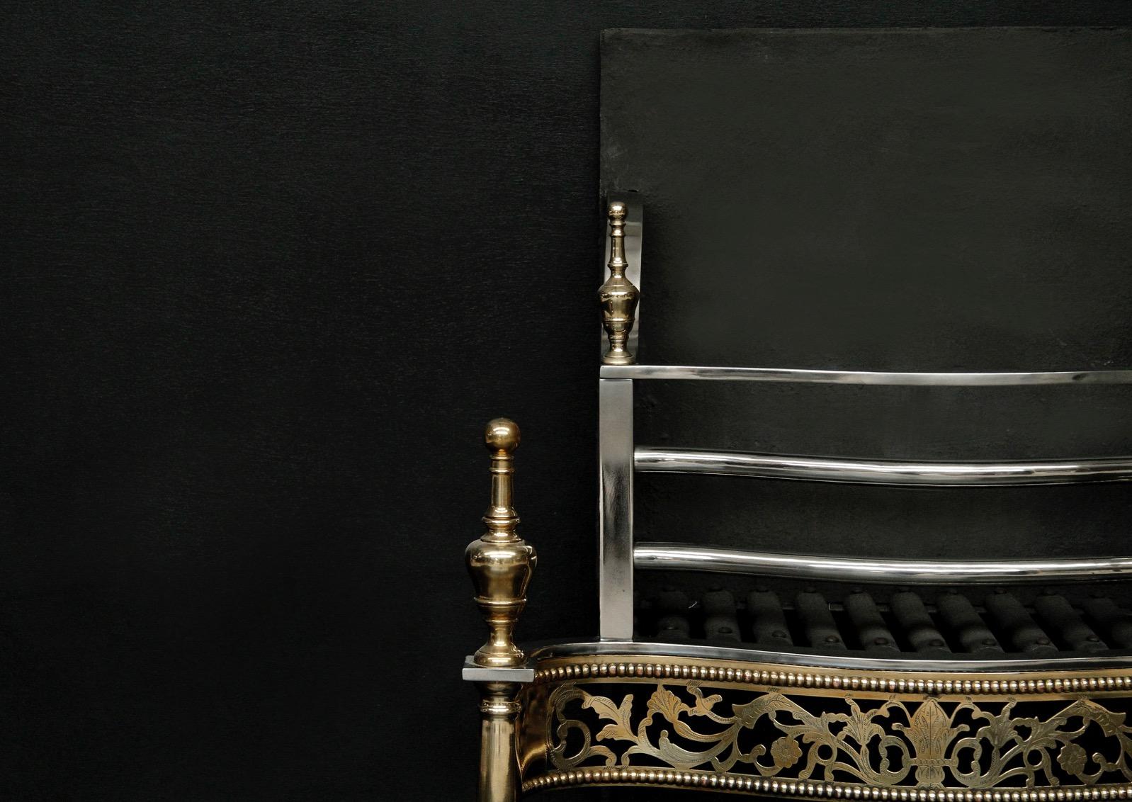 An 18th century style brass and steel fire basket. The pierced serpentine fret with decorative beading above and below. The cylindrical legs surmounted by turned brass finials. Square cast iron back behind. Modern.

Width At Front:	655 mm      	25