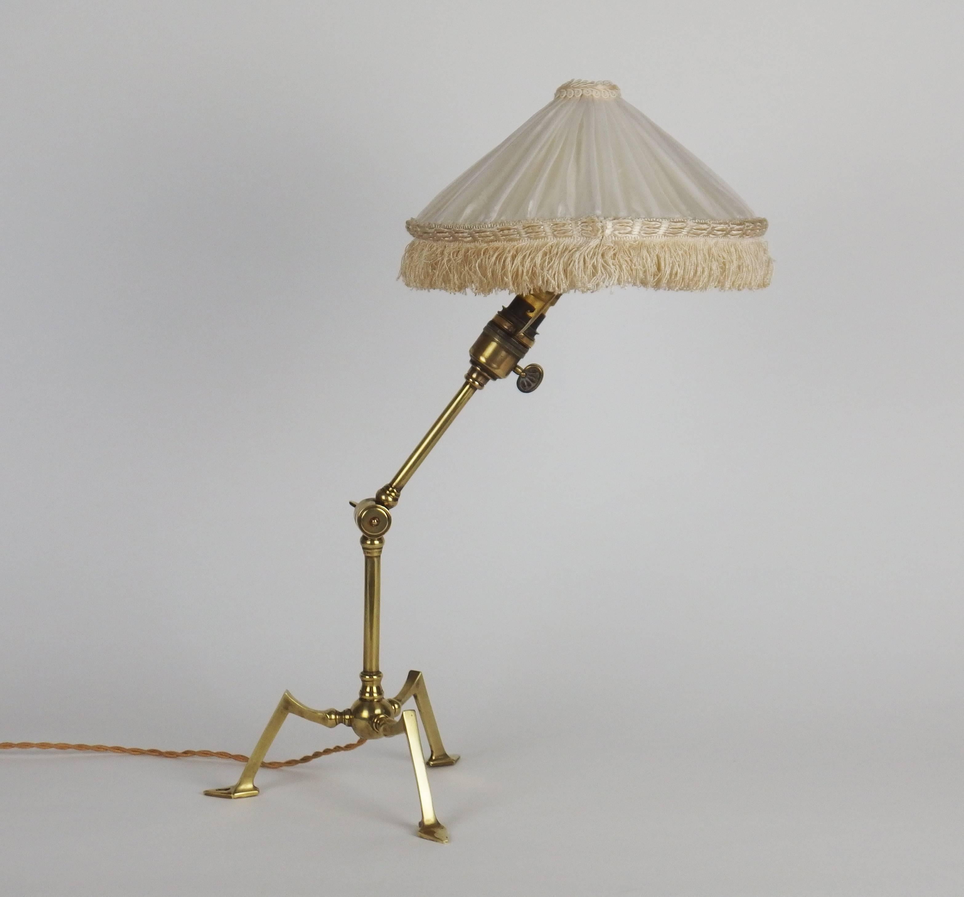 A three feet adjustable brass table lamp with a swivelling shade support, thanks to this system and the drilled hole in one foot, this lamp can be used as a sconce.
Measure: Height without the shade: 13.3in
This table lamp is attributed to W.A.S