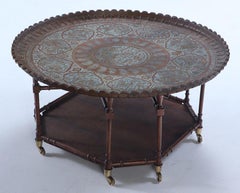 A brass tray top coffee table with a faux bamboo wood base circa 1960.
