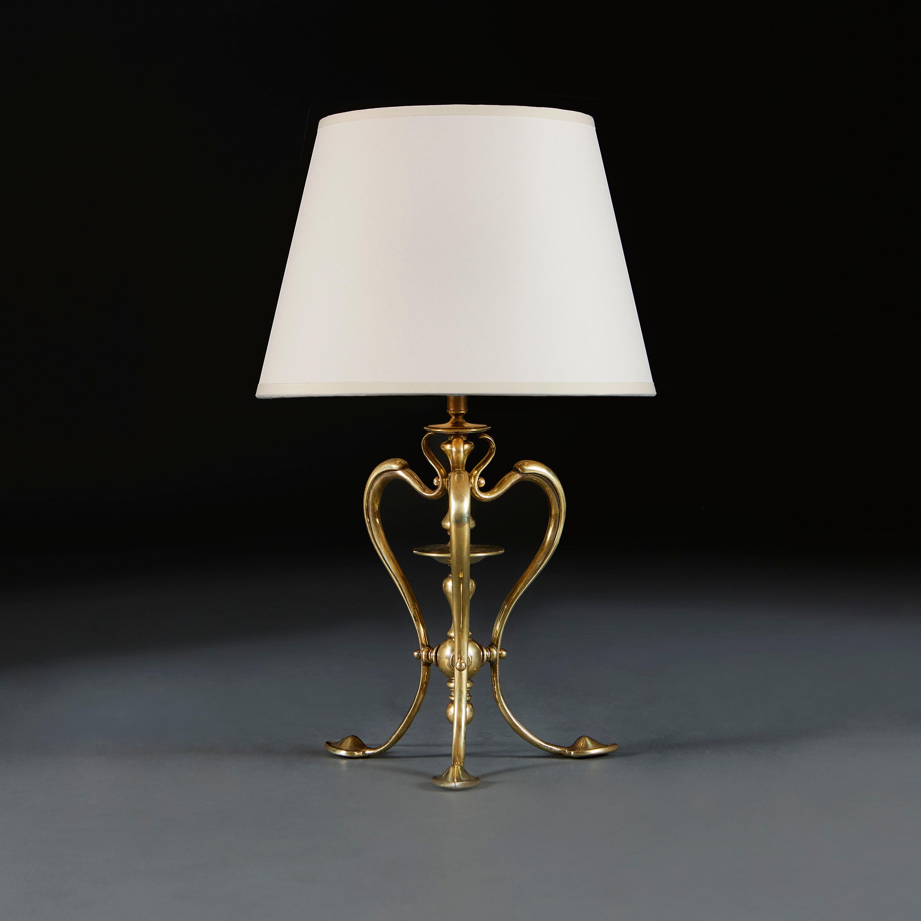 England, circa 1900

An early twentieth century brass lamp by W.A.S Benson, of tripod form, the scrolling legs surrounding a central stem, and terminating in heart shape pad feet.

Height 27.00cm
Height with shade 50.00cm
Width of base