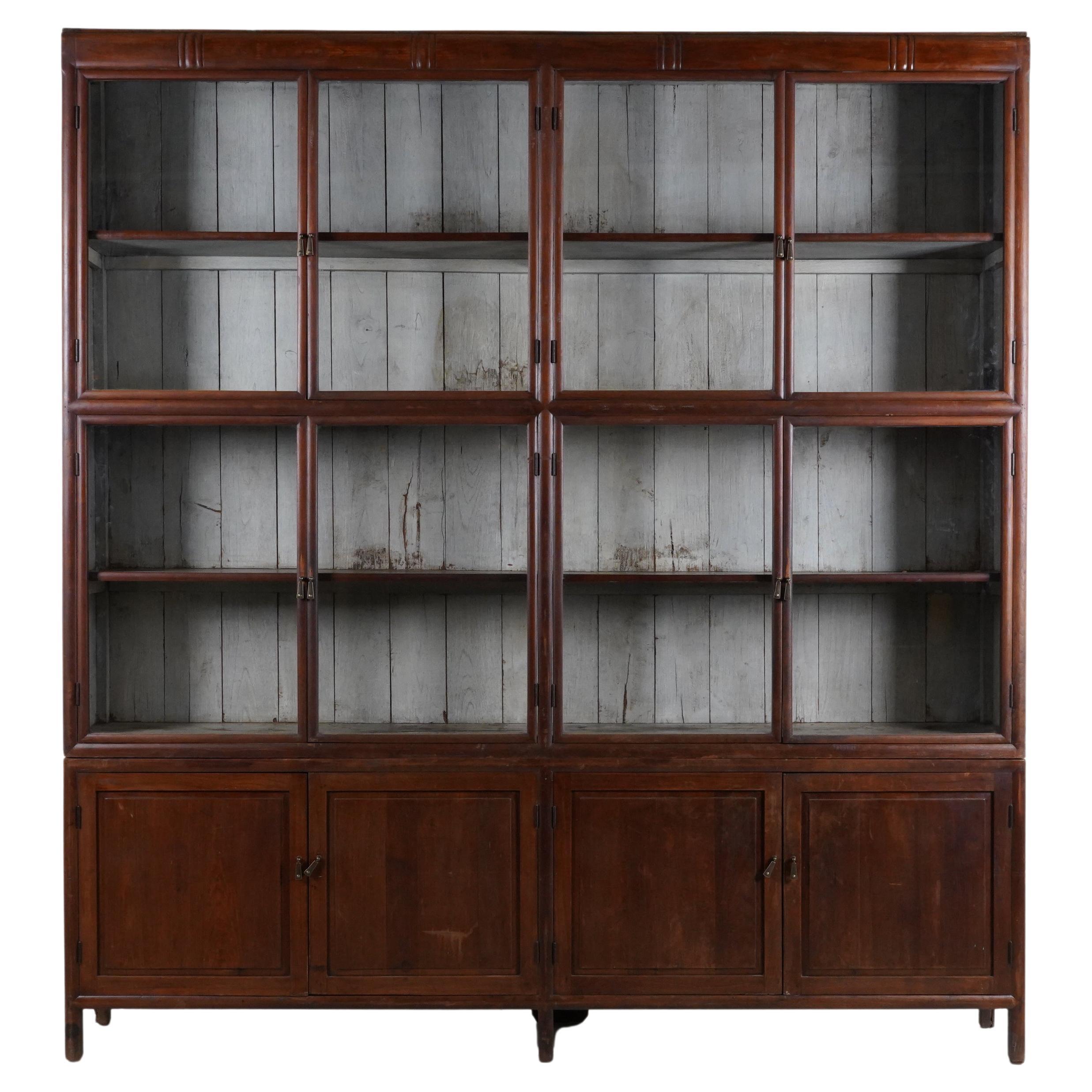 A British Colonial Art Deco Teak Bookcase with Lower Storage  For Sale