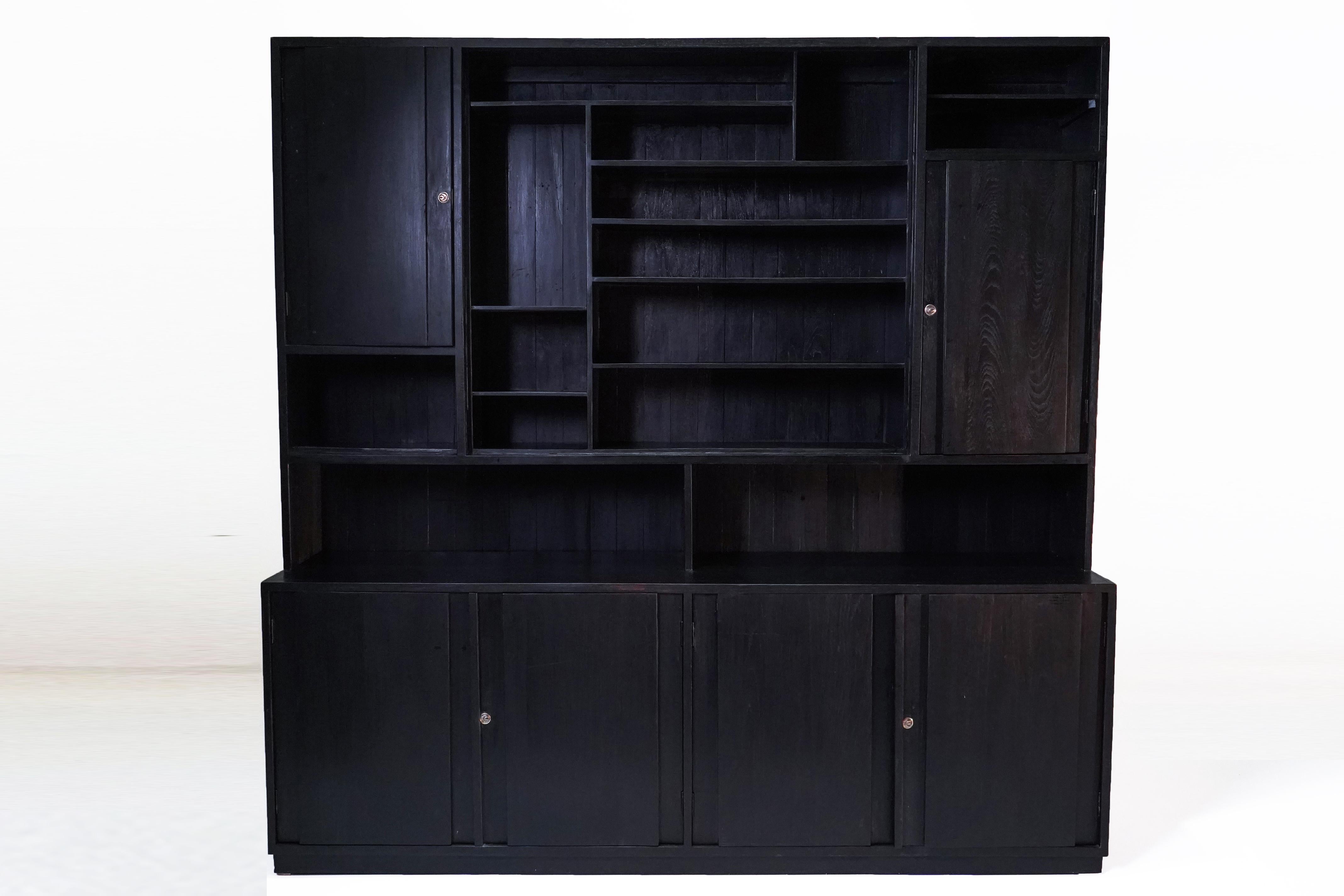 This clean-lined and substantial  book cabinet was made from solid Teak wood and dates to the 1940's. It is is in the art modern or early Mid-Century Modern style. During the late British empire in India and Burma much furniture was made in the
