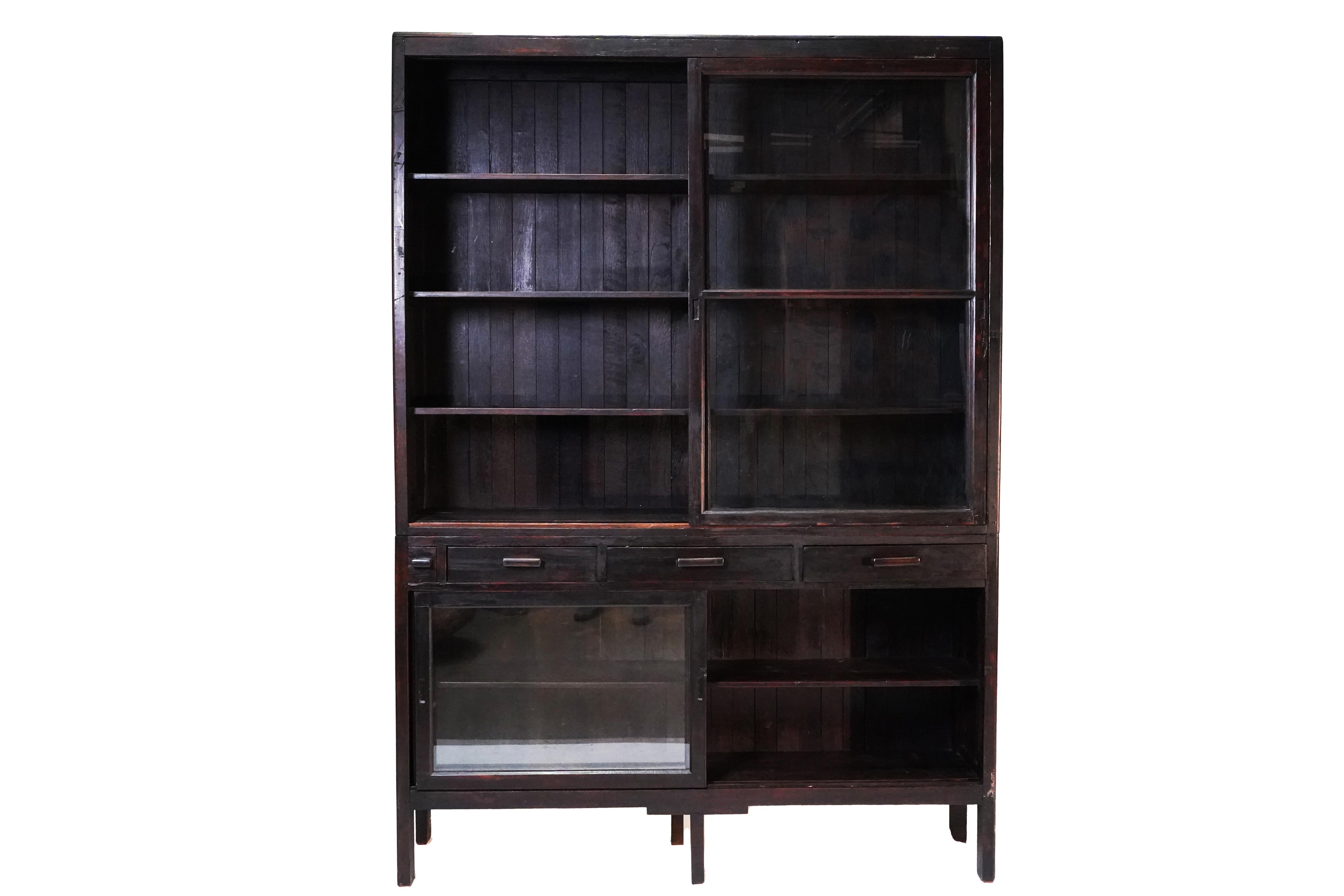 This solid teak bookcase was made in a modern, simple style in Rangoon, Burma, near the very end of the British Empire.   We call these pieces by different names; 