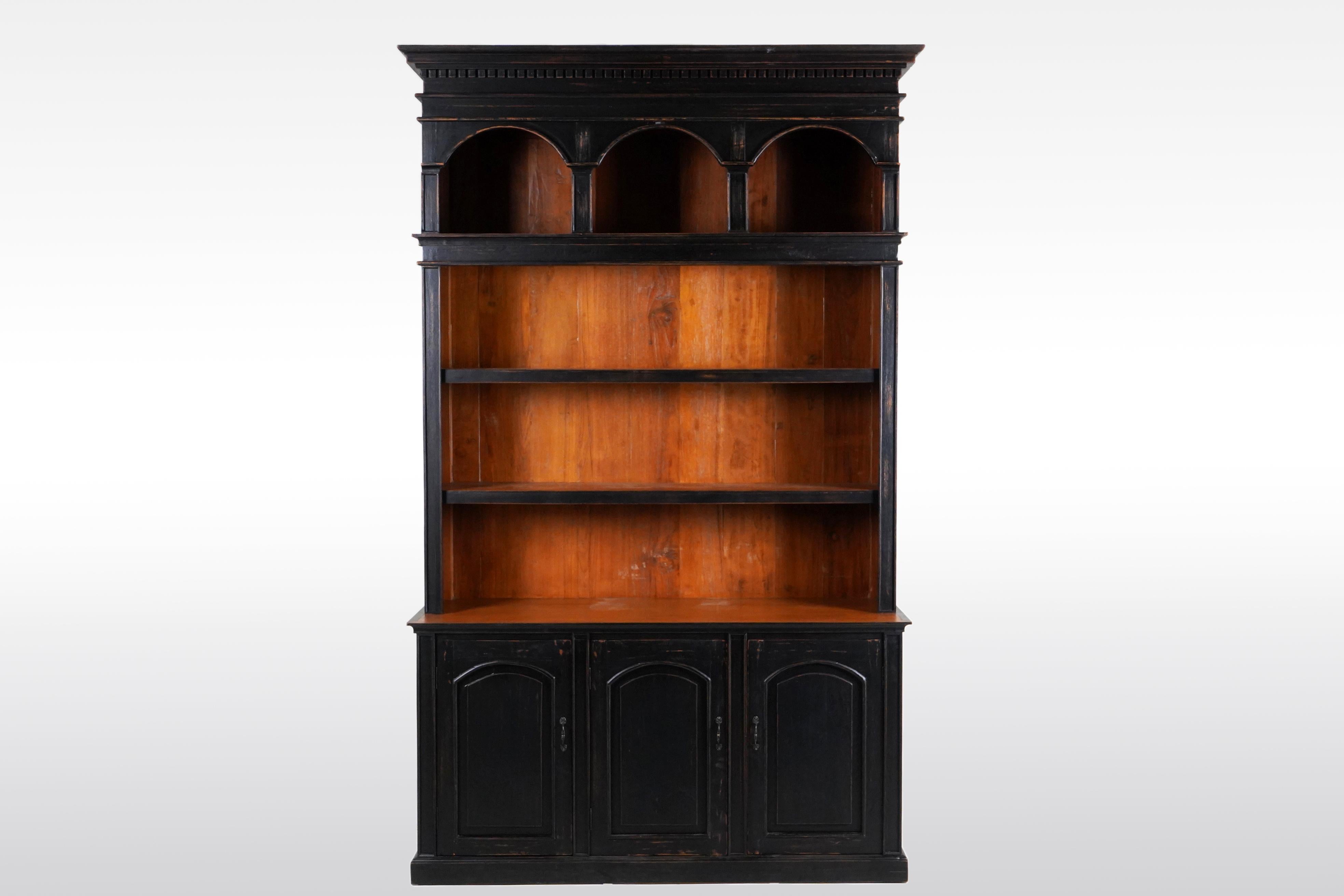 This open large antique book cabinet was made from solid teak wood and dates to the 19th Century. During the British Empire in India and Burma much furniture was made in the Anglo-Indian style using native hardwoods and native craftsmen. Styles