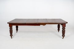 A British Colonial Dining Table on Casters with Extension Leaves