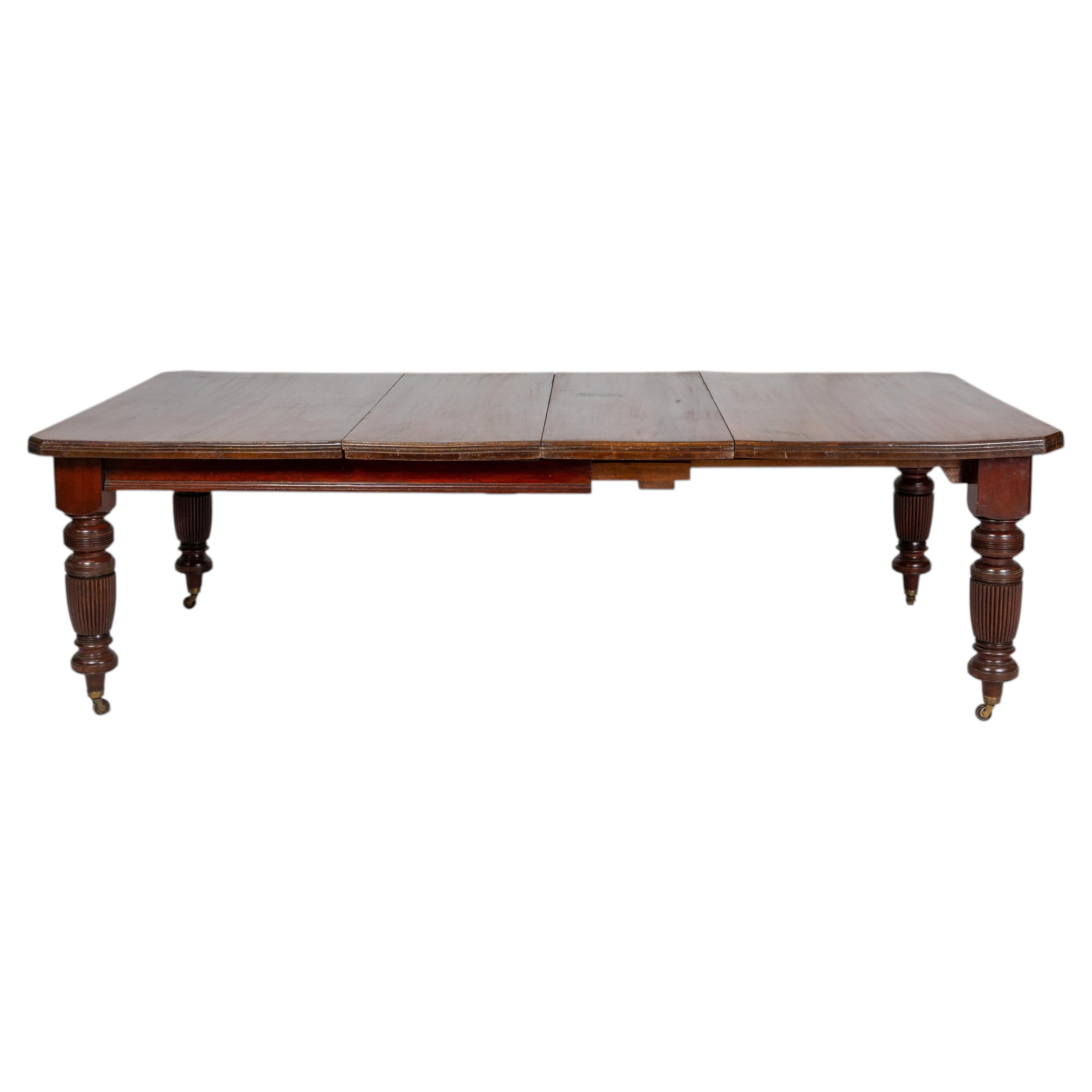 A British Colonial Dining Table on Casters with Extension Leaves