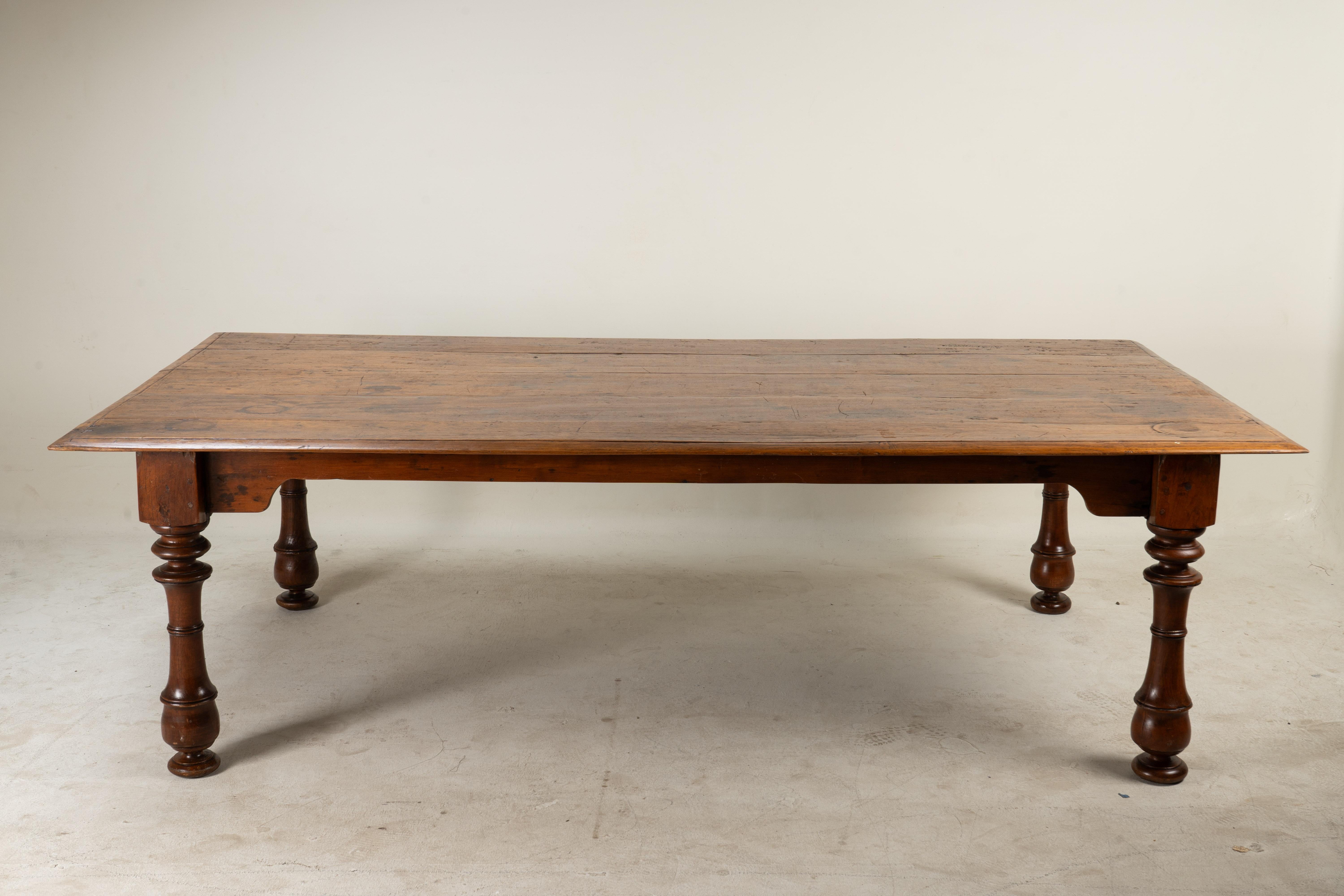 This British Colonial teak wood dining table with bevel edges typically embodies the elegant, yet practical design elements that arose during the British colonial era in the 19th and early 20th centuries. These tables are often crafted from solid