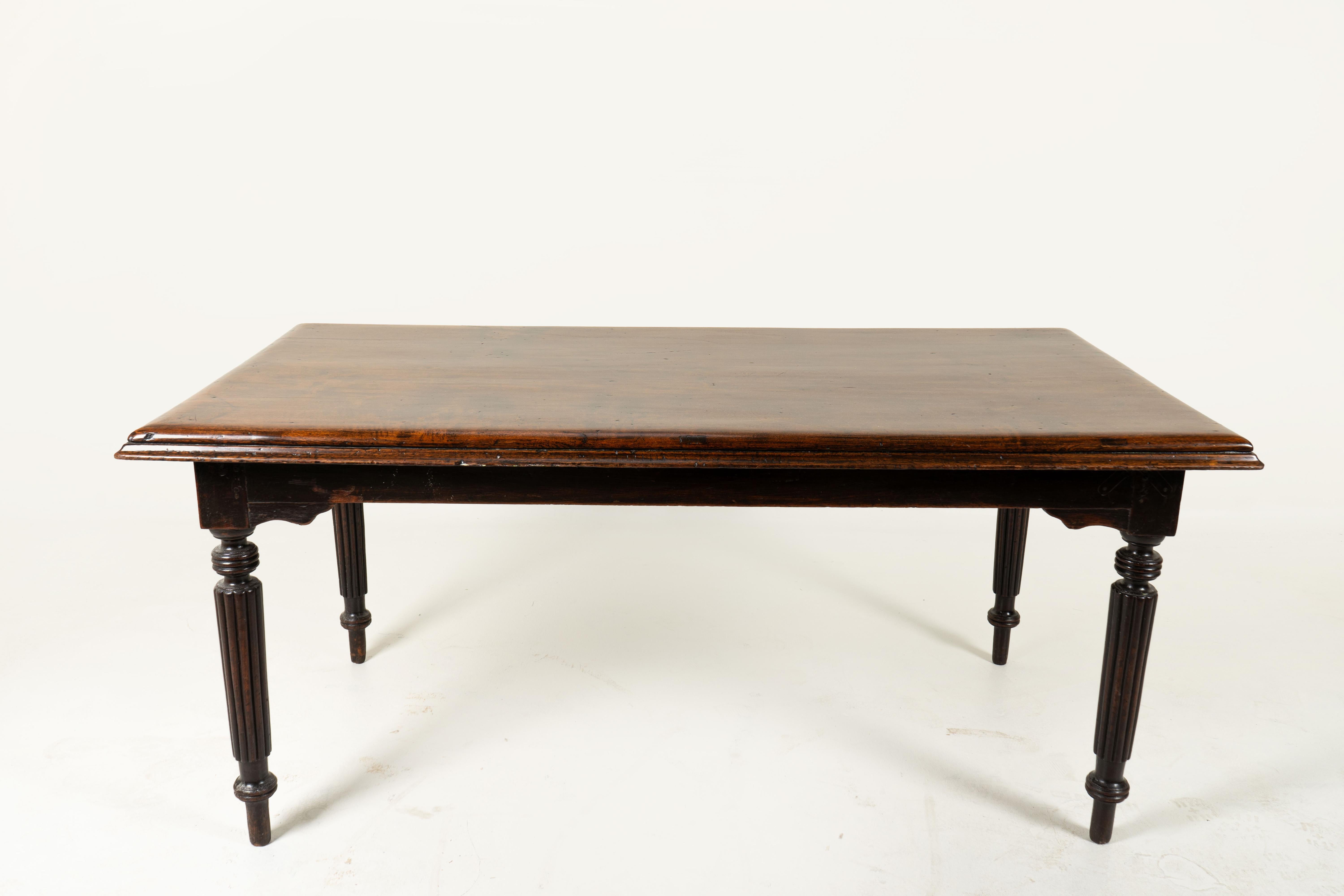 This compact and elegant dining table was made from teakwood in Rangoon, Burma in the 1890's. It features elegantly turned legs and a rare single-piece top. During the height of the colonial era in the late 19th Century, Rangoon was a booming