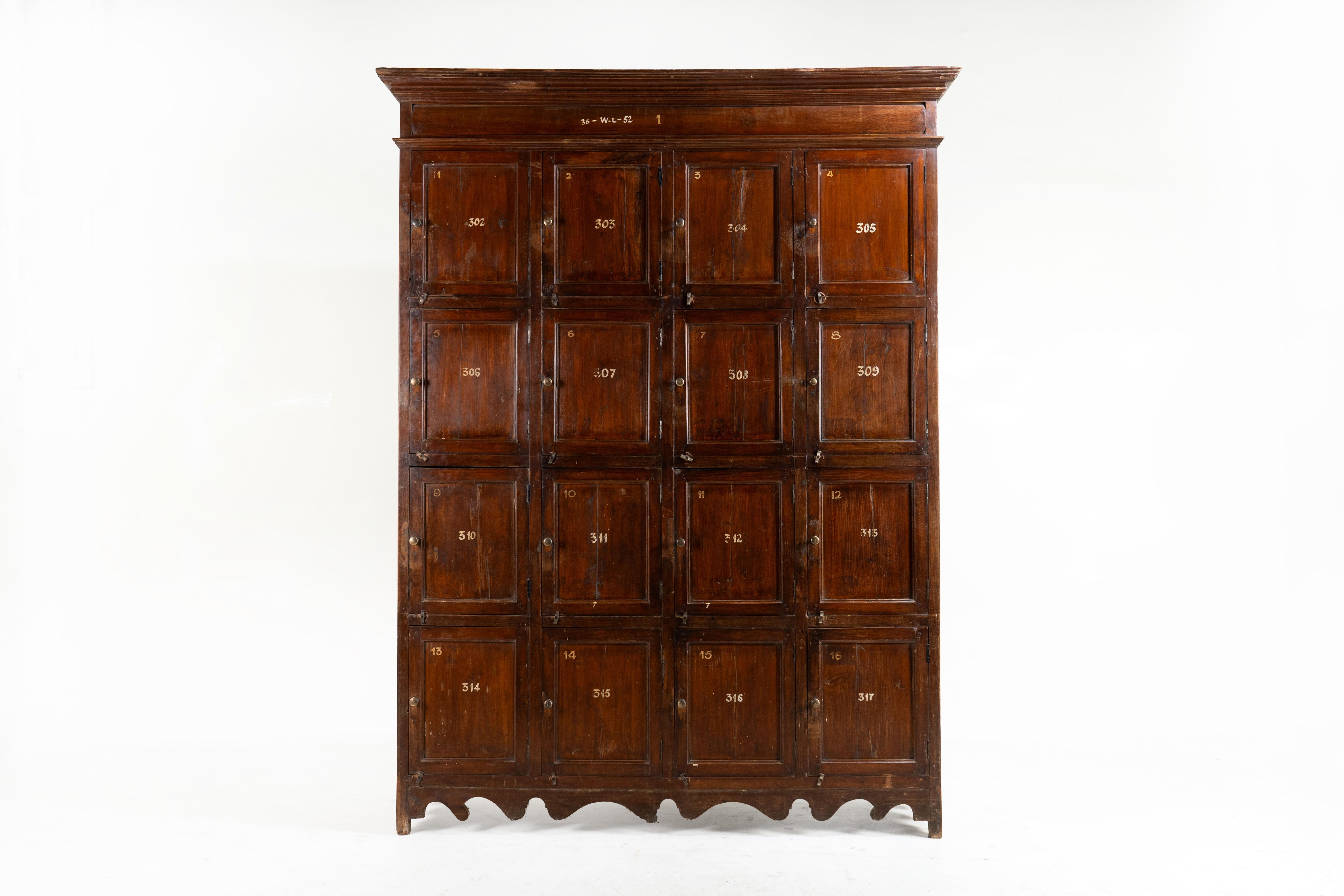 This handsome gym locker was crafted from Teak in 1930, reflecting the British preference for durable materials suited to tropical climates. Featuring brass hardware and delicate carving at its base, or detailing, this locker was used for clothing