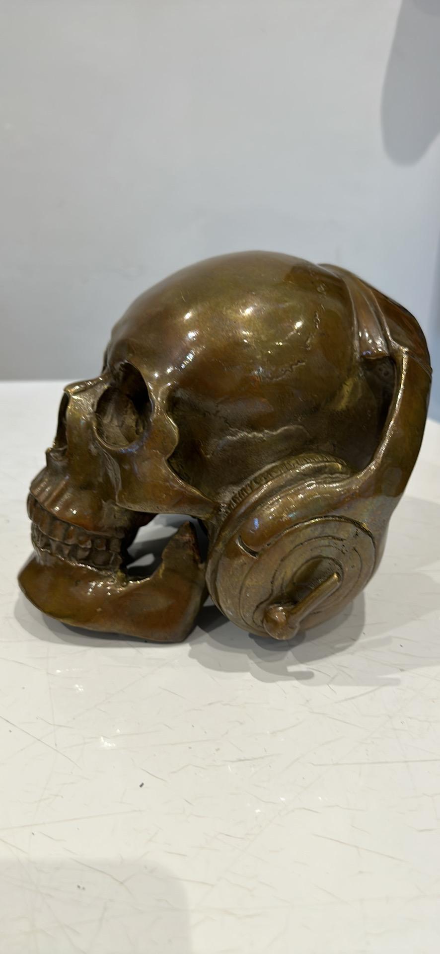 bronze skull with headphones