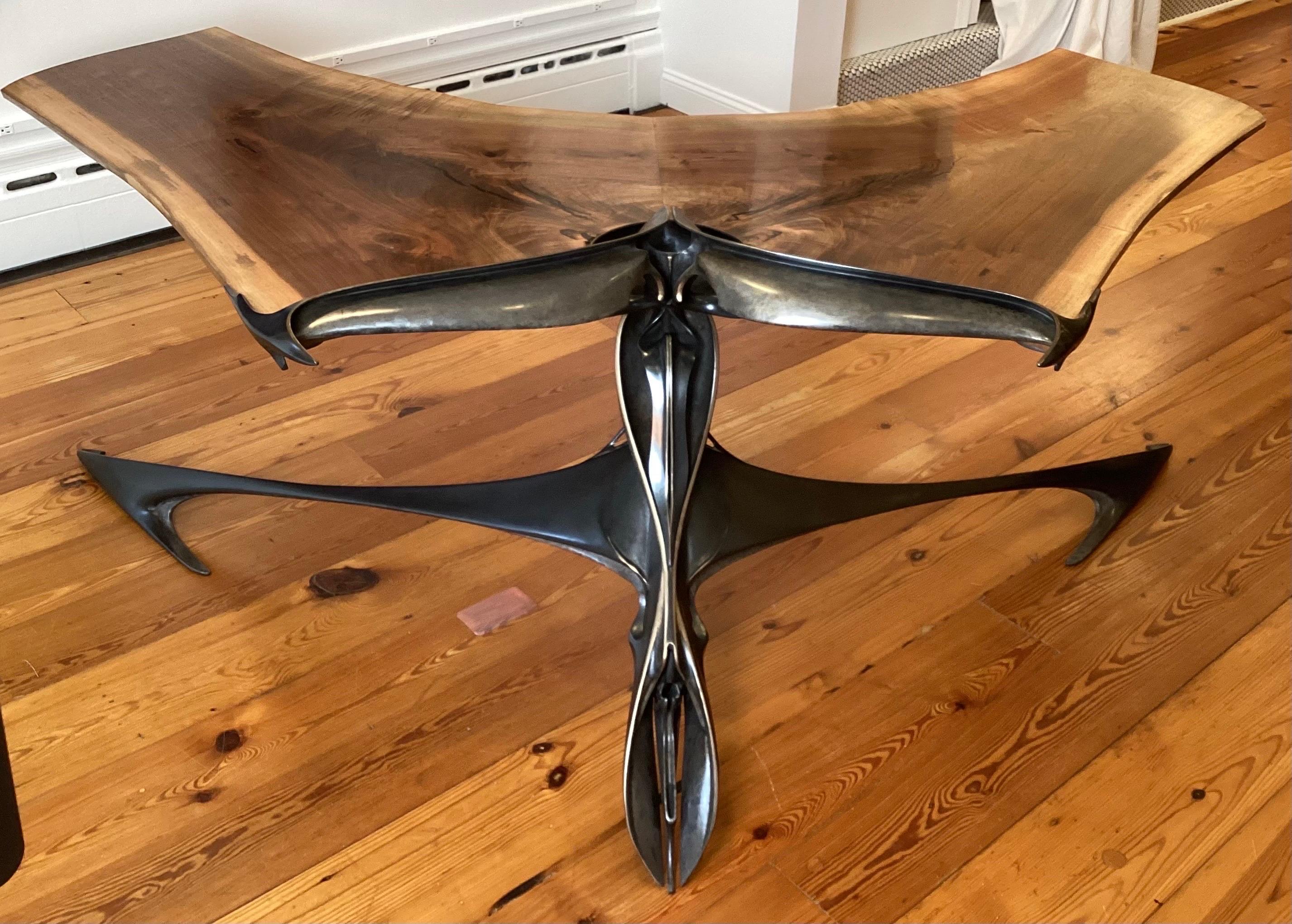 This is a one of a kind desk with a sculpted bronze base and live edge walnut top.  The artist, Lawrence Welker IV created the base to resemble a moth.  The desk surface is two joined live edge book matched slabs of solid walnut representing wings. 