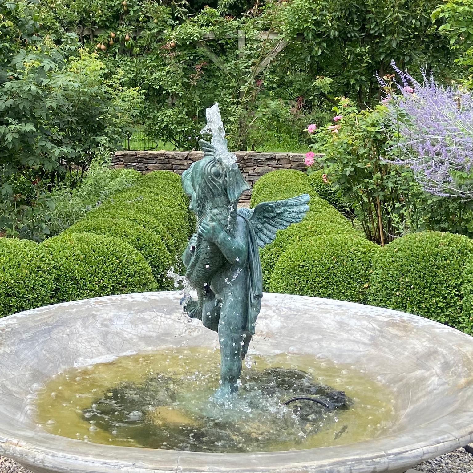 A Bronze Cherub Holding a Fish In Good Condition For Sale In Katonah, NY