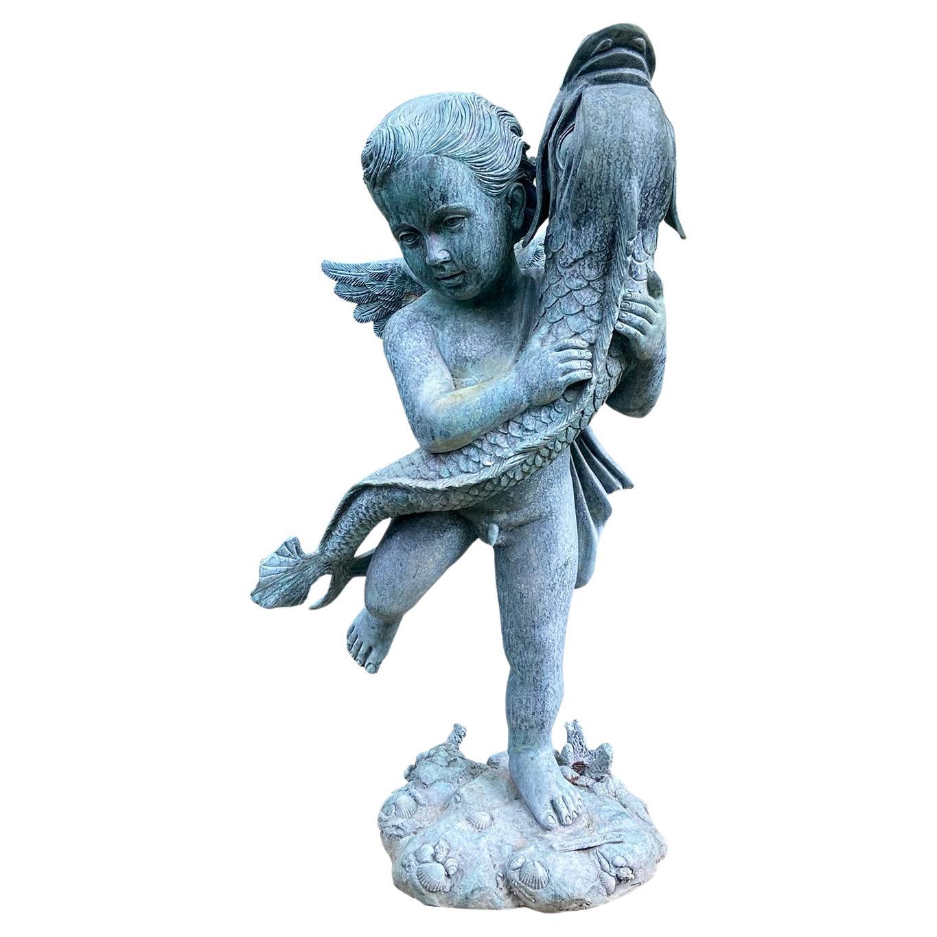 A Bronze Cherub Holding a Fish