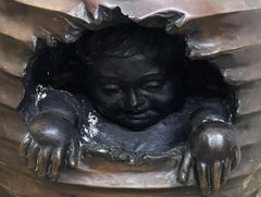 A bronze-colored side pedestal or plant table