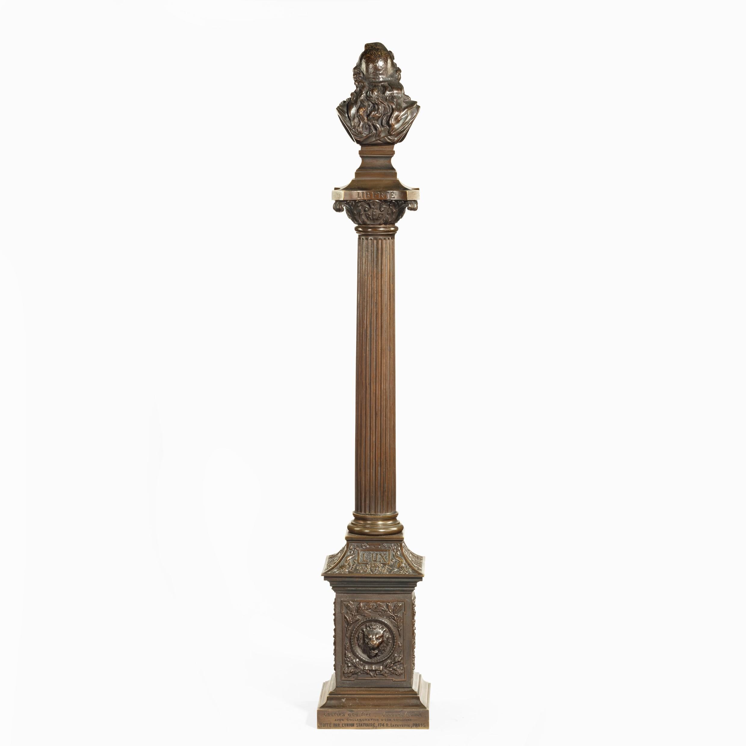 A bronze column depicting ‘La Colonne de la Republique’ dated 1889, after Paul LeCreux, the classical fluted column is surmounted by a bust of Marianne, one of the most prominent symbols of the French Republic, wearing a Phrygian cap, the sides