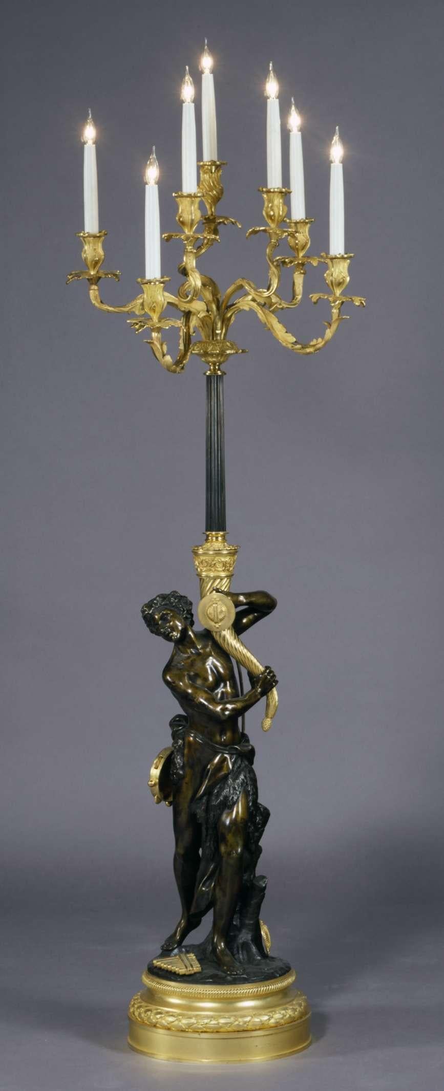A very fine gilt and patinated bronze floor standing candelabrum, after a model by Clodion.

French, circa 1880.

Claude Michael Clodion, (1738-1814), was the son-in-law of sculptor Augustin Pajou; he trained in Paris in the workshops of Lambert