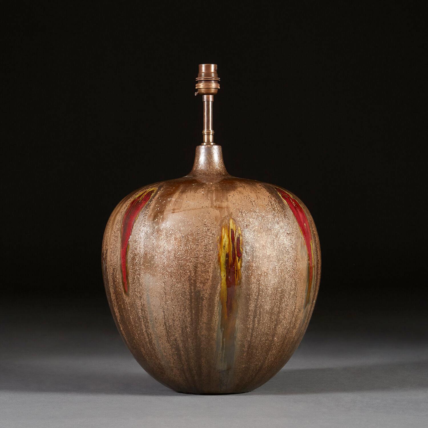 A large scale art pottery vase of ovoid form, with unusual bronze glaze and overlaid red and gold drip glaze decoration.

Please note that the lampshade is not included, and that the lamp is currently wired for the UK. Please enquire about