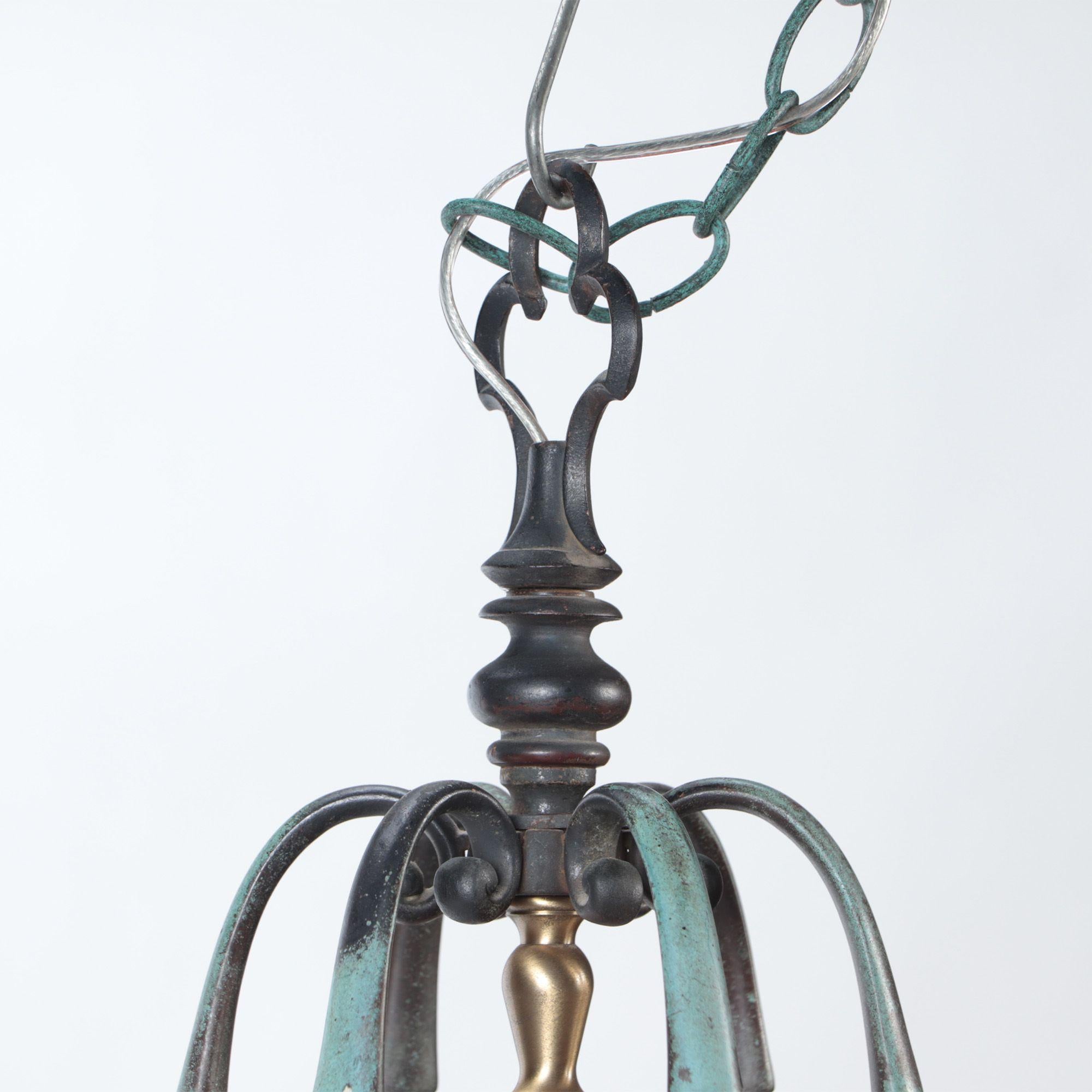 A bronze lantern with grape and leaf motif and green patina, circa 1920.