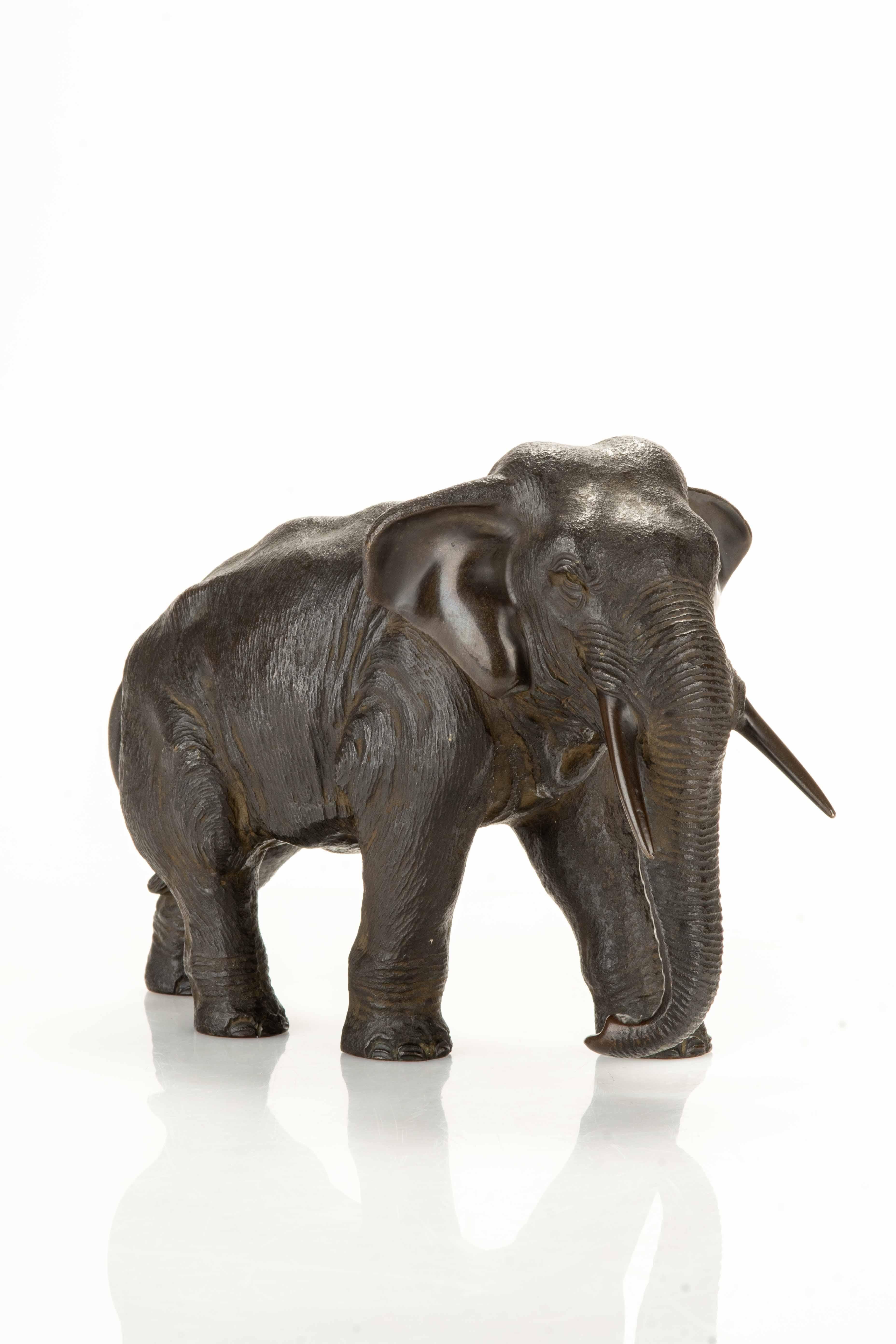 Japanese A bronze okimono depicting a walking elephant For Sale