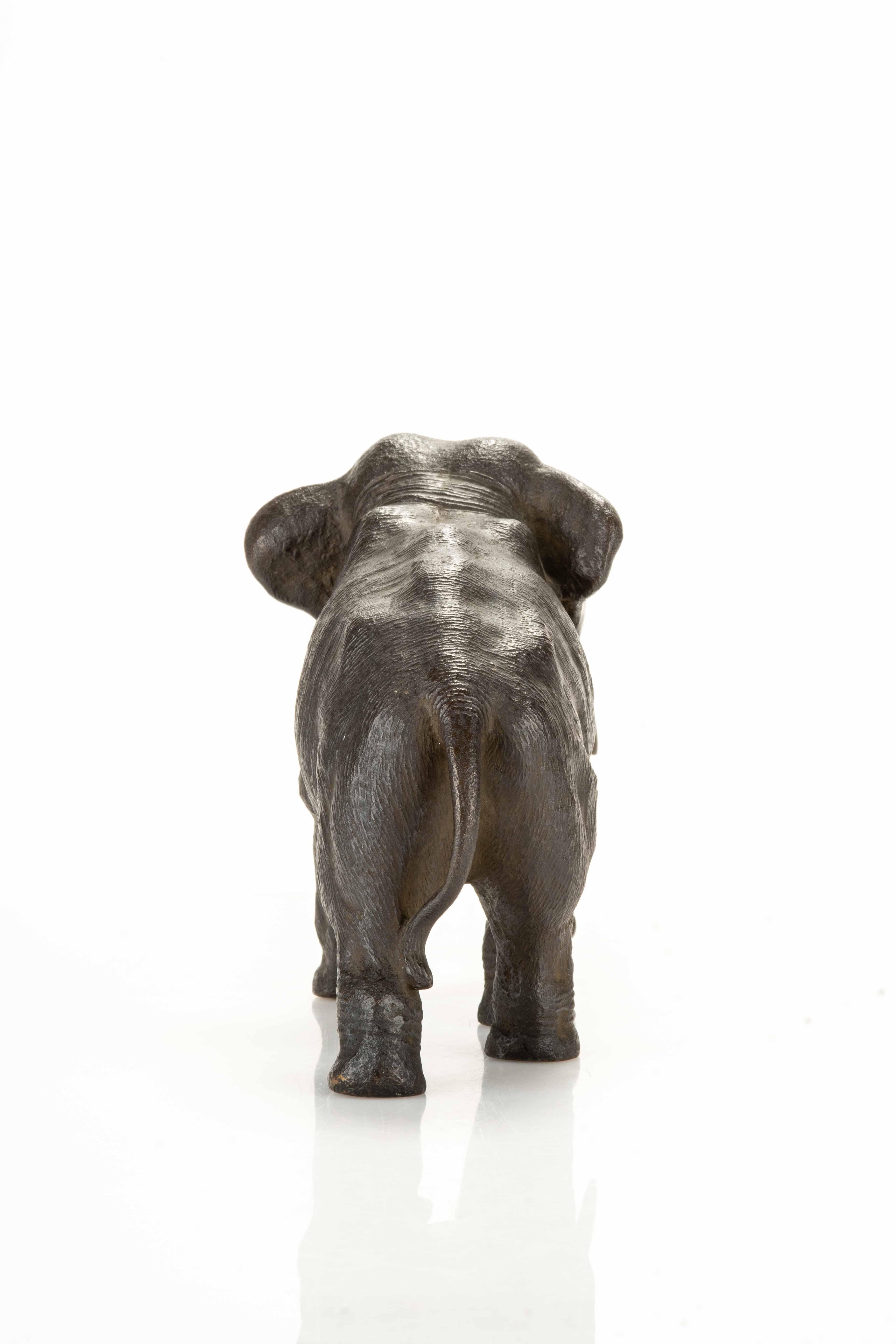 Metalwork A bronze okimono depicting a walking elephant For Sale