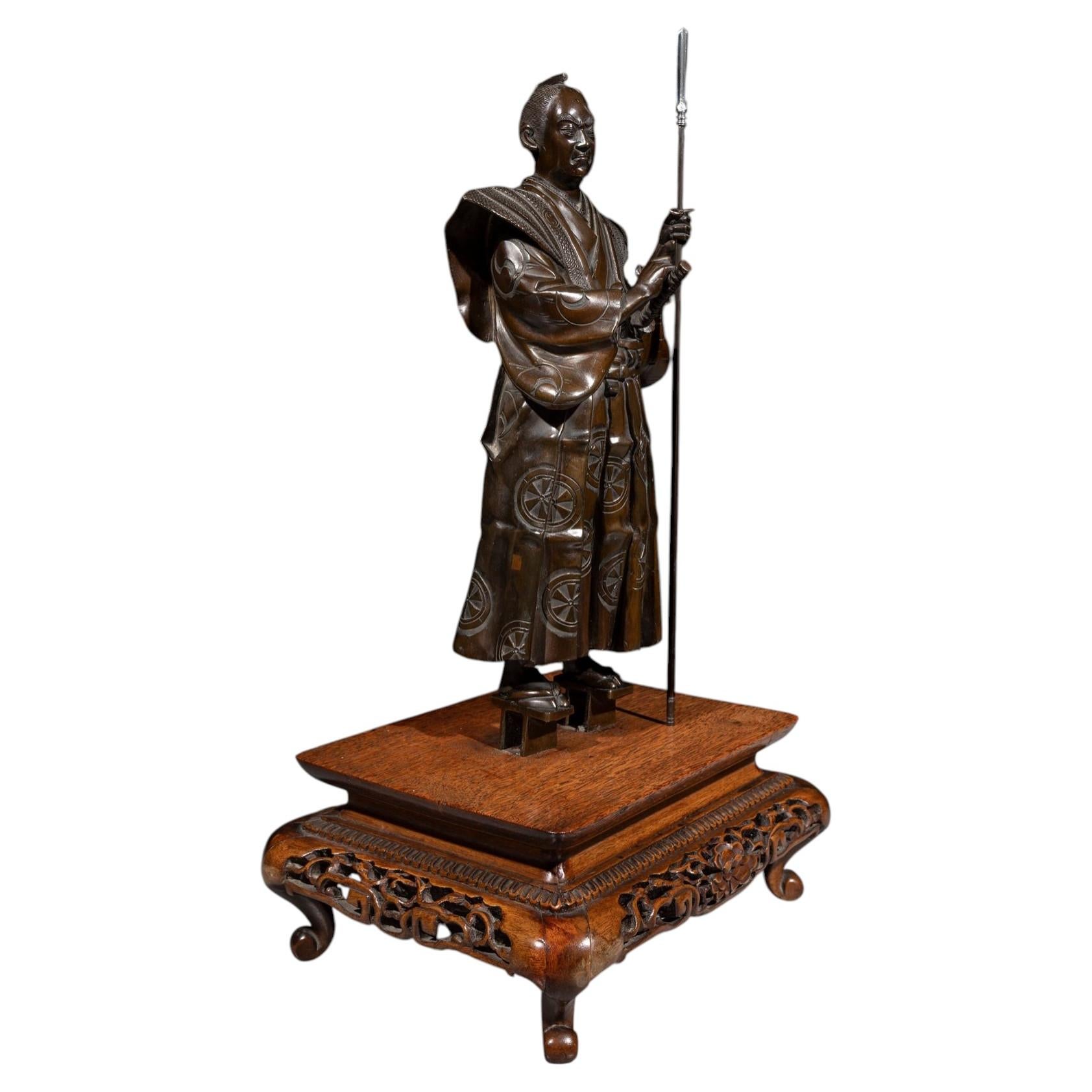 A bronze okimono of a samurai with a yari and katana, signed Gyokko