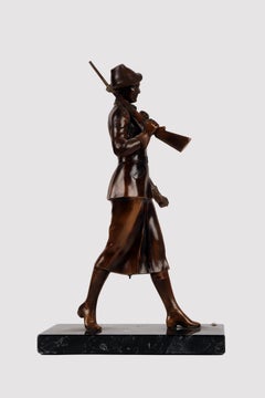 A bronze sculpture depicting a huntress with rifle, Austria 1920.
