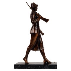 A bronze sculpture depicting a huntress with rifle, Austria 1920. 