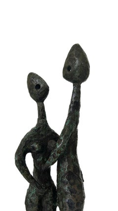 A bronze sculpture of a family by Charles Stratos