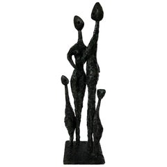 A bronze sculpture of a family by Charles Stratos