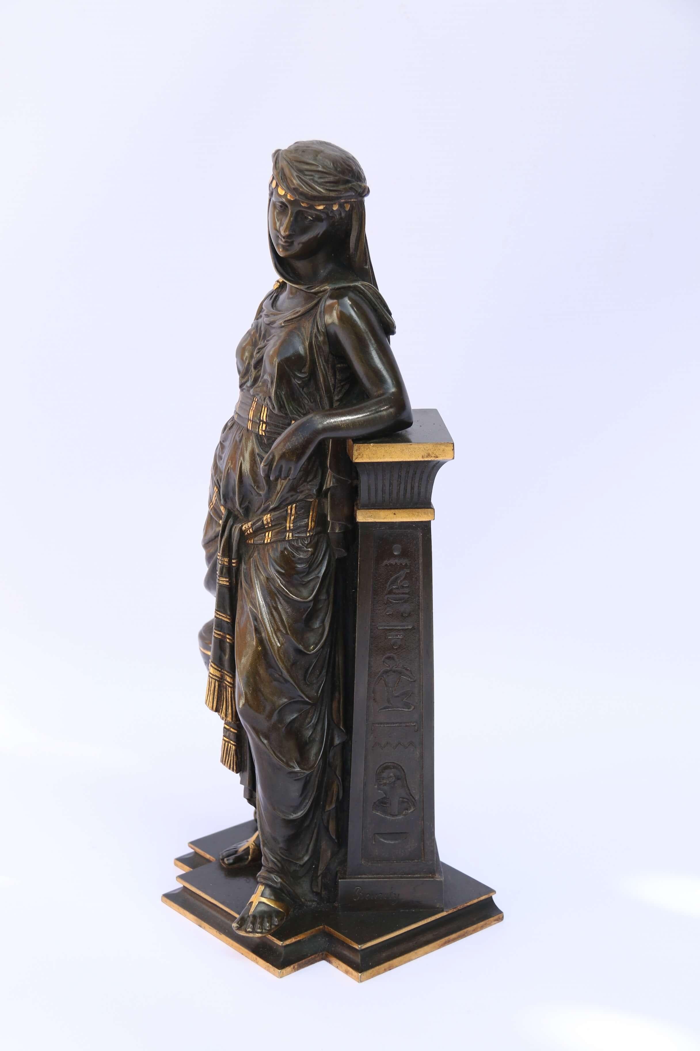 This top quality example by Eutrope Bouret (1833-1906) is depicting the classical young Egyptian maiden gathering water in a vessel. She is dressed in a typical robe and headdress of the period and is resting against a pilaster with hieroglyph