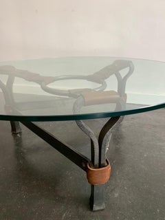 A brutalist coffee table in iron and leather