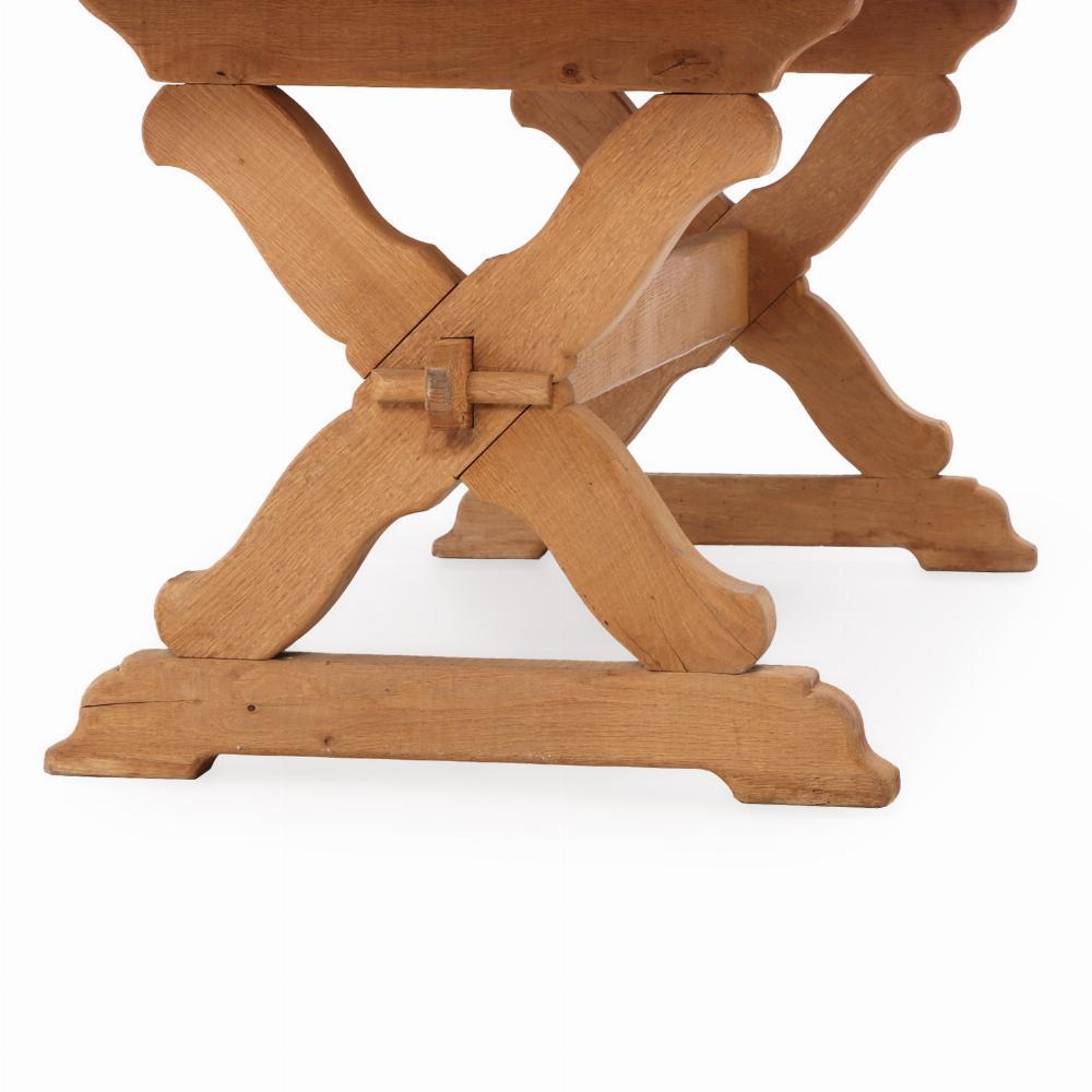 This farmhouse table has all the charm for you country living! The top detaches from its X form base. Stripped of its finish, this table sings of its natural oak tone. 