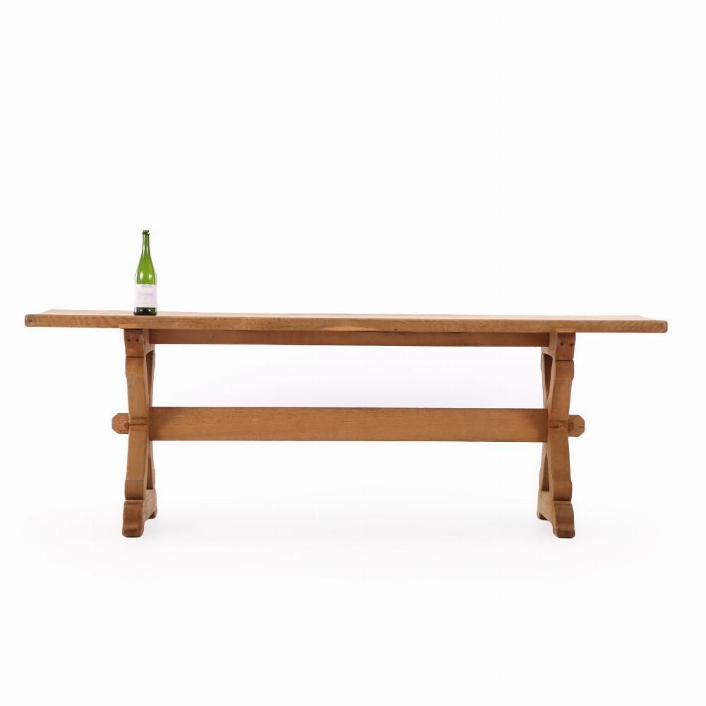 A Brutalist French oak sawbuck table, C. 1950. In Good Condition For Sale In Philadelphia, PA