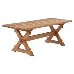 A Brutalist French oak sawbuck table, C. 1950.